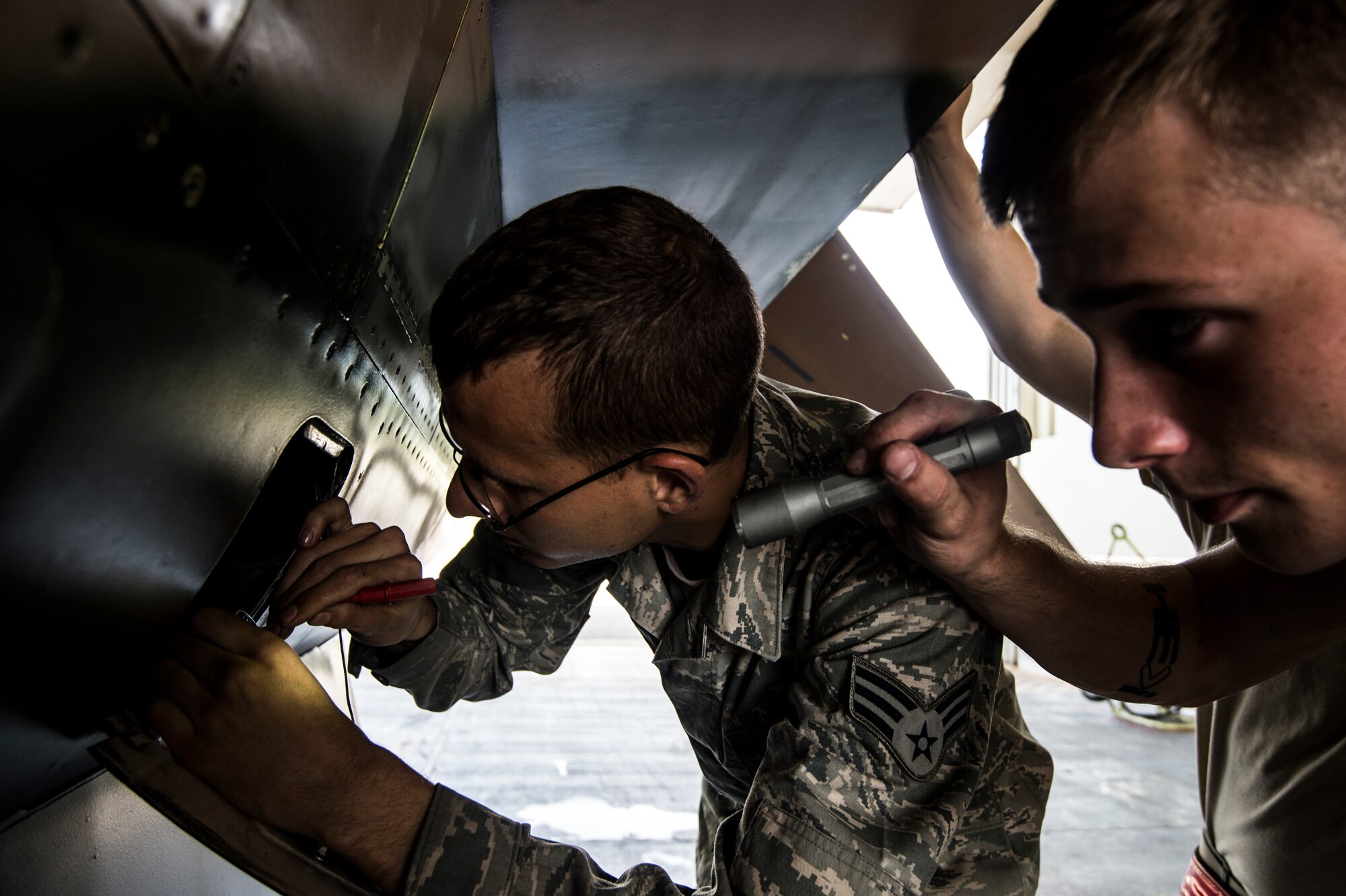 Senior Airman Jacob Hamblen and Airman 1st Class Jeremiah Cass, 354th Aircraft Maintenance Squadron engines specialists, inspect an F-16C Fighting Falcon before take-off at Eielson Air Force Base, Alaska, Aug. 4, 2014. The 354th AMS provides mission ready mission ready aircraft to support the wing's F-16 aggressor mission that includes home station, the exercise RED FLAG-Alaska and Aggressor road shows. (U.S. Air Force photo by Staff Sgt. Stephany Richards/ Released)