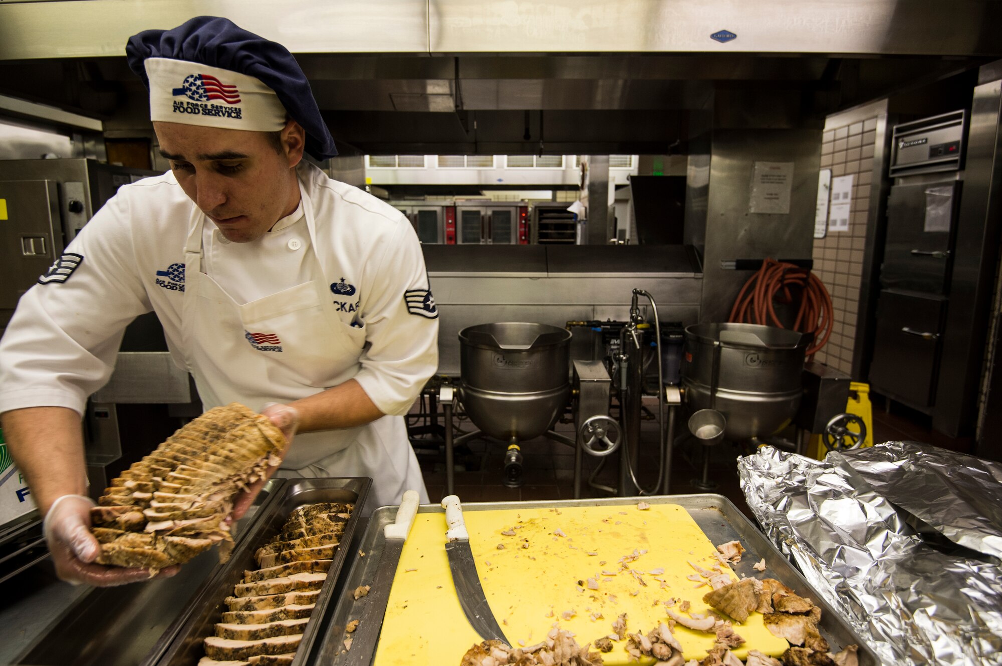 Staff Sgt. Michael Lockeart, 354th Force Support Squadron shift leader, prepares turkey for a lunch service at Eielson Air Force Base, Alaska, Aug. 4, 2014.  The dining facility feeds about 400 Airmen a day.  The 354th FSS has  more than 450 assigned military and contract personnel that provide manpower, personnel services, and programs to enhance morale, quality of life, personnel readiness, family support, and education and training for the Eielson AFB community. (U.S. Air Force photo by Staff Sgt. Stephany Richards/ Released)