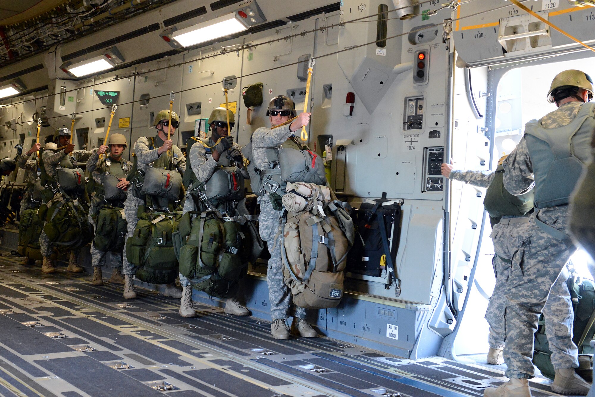 Soldiers from the 1st Special Forces Group (Airborne) prepare to perform static-line jumps from a C-17 Globamaster III aircraft during joint Operation Desert Cougar Aug. 4, 2014, near Schoonover, Calif. During the exercise, 15 soldiers successfully performed static-line jumps into the insertion zone. (U.S. Air Force photo/Airman 1st Class Jacob Jimenez) 