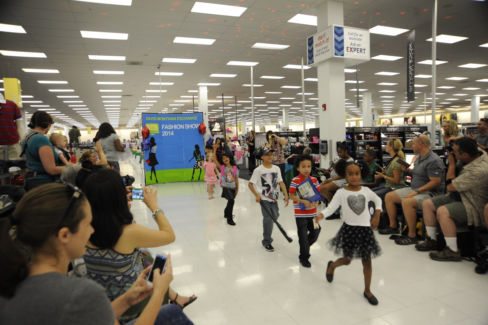 Fashion models do a final walk at the a Back-to-School Fashion Show held by the Enlisted Spouse Association and Base Exchange at Davis-Monthan Air Force Base, Ariz., Aug. 2, 2014. More than 25 dependents modeled clothing sold at the BX during the show. (U.S. Air Force photo by Airman 1st Class Betty R. Chevalier/Released)