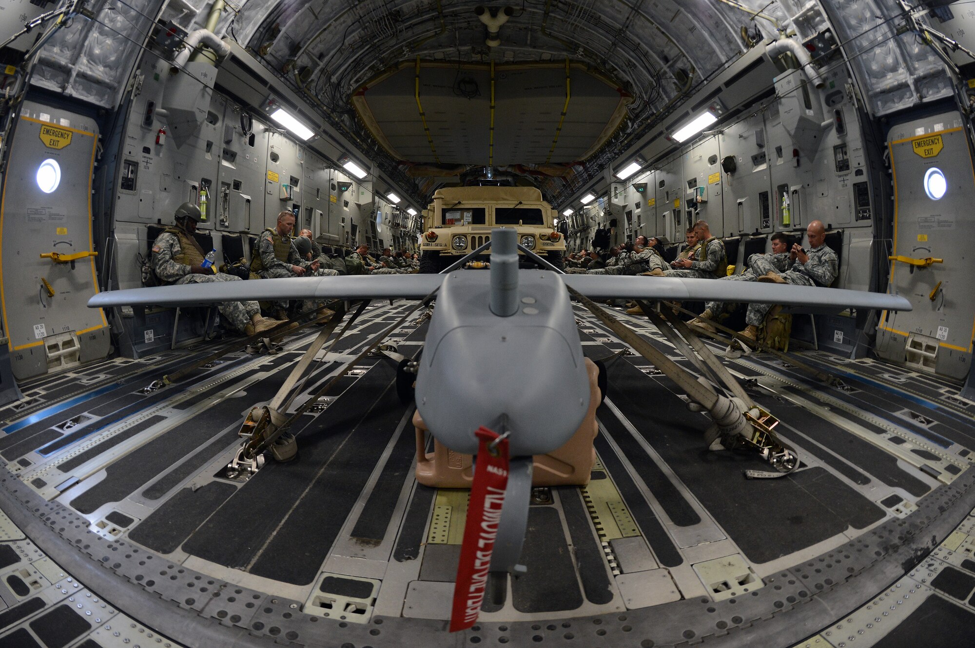 Soldiers from the 1st Special Forces Group (Airborne) on a C-17 Globemaster III wait to land Aug. 4, 2014, while enroute to Schoonover, Calif., as part of Operation Desert Cougar, a joint readiness exercise. Soldiers from the 1st SFG (A) worked with Airmen from the 446th Airlift Wing and the 22nd Special Tactics Squadron to transport special forces assets which included an unmanned aircraft, a Humvee and support personnel. (U.S. Air Force photo/Airman 1st Class Jacob Jimenez)