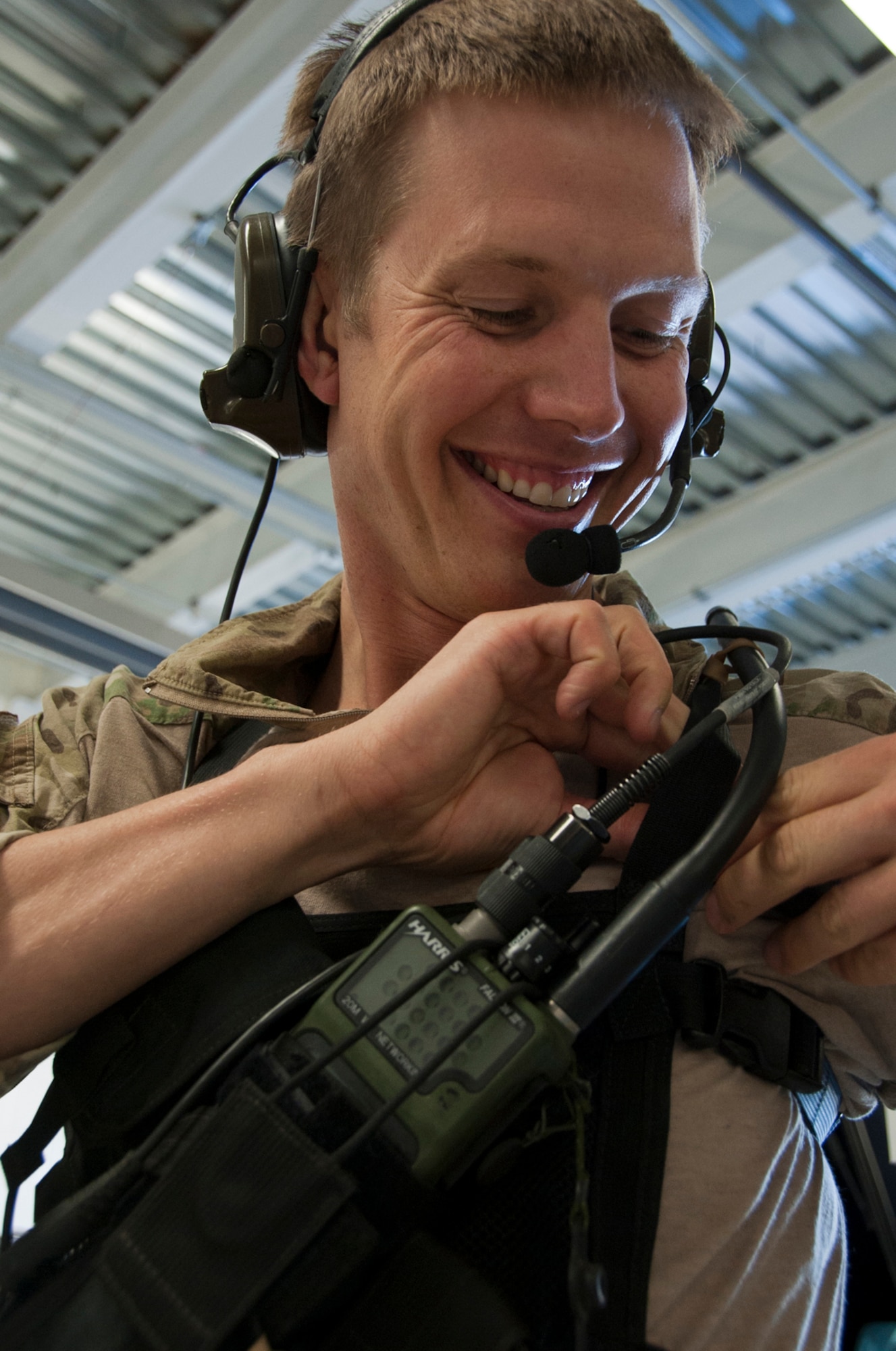 Senior Airman Jason Hughes, 212th Rescue Squadron pararescueman, prepares his radio for a training mission on Joint Base Elmendorf-Richardson, Alaska, July 30, 2014. The Rescue Squadron trains their team for any military and civilian missions where they may be tasked to recover, rescue or execute a medical evacuation. (U.S. Air Force photo/Airman 1st Class Tammie Ramsouer)