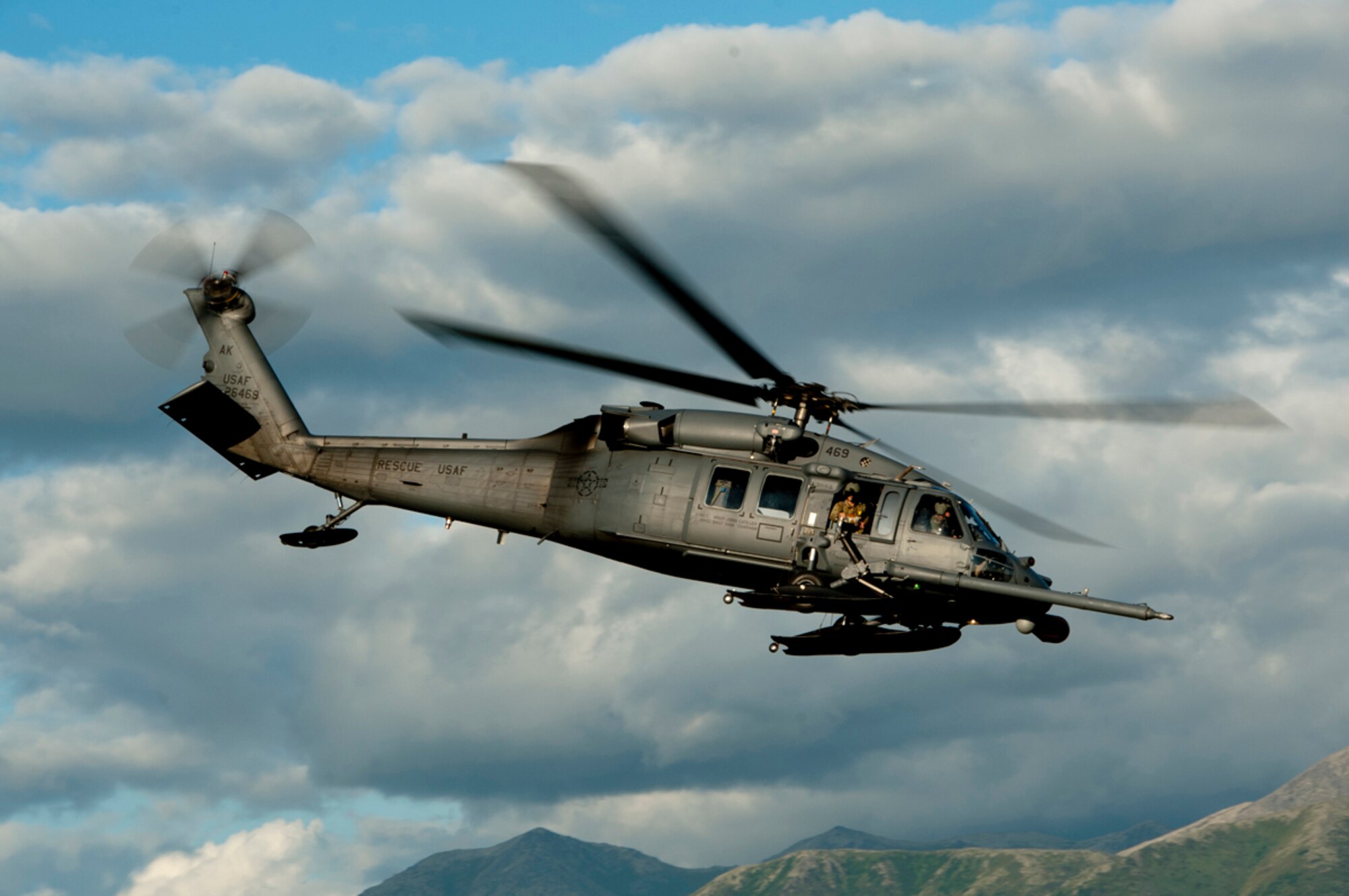 A HH-60 Pave Hawk flies over Malemute drop zone during a pararescue training mission on Joint Base Elmendorf-Richardson, Alaska, July 30, 2014. The Rescue Squadron trains with many of the aircraft units on base to carry out routine training missions to stay proficient in their required skillsets. (U.S. Air Force photo/Airman 1st Class Tammie Ramsouer)