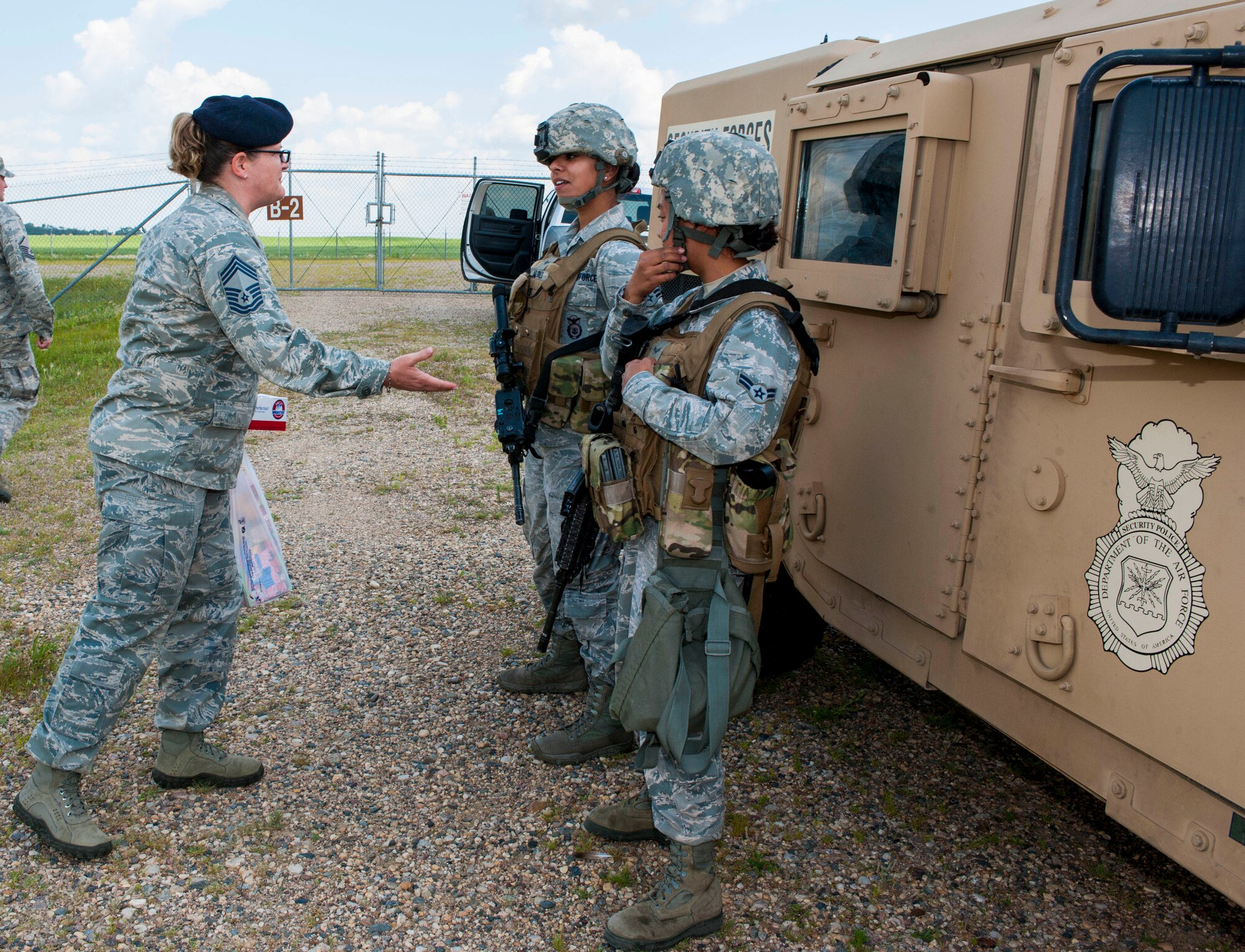 Chief Master Sgt. Melissa Permar, 791st Missile Security Forces Squadron security forces manager, speaks with Airmen from the 791st MSFS, during a morale visit to the missile complex in North Dakota, July 30, 2014. Permar covered approximately 210 miles and stopped at several launch facilities in the missile complex during the visit. (U.S. Air Force photo/Senior Airman Stephanie Morris)
