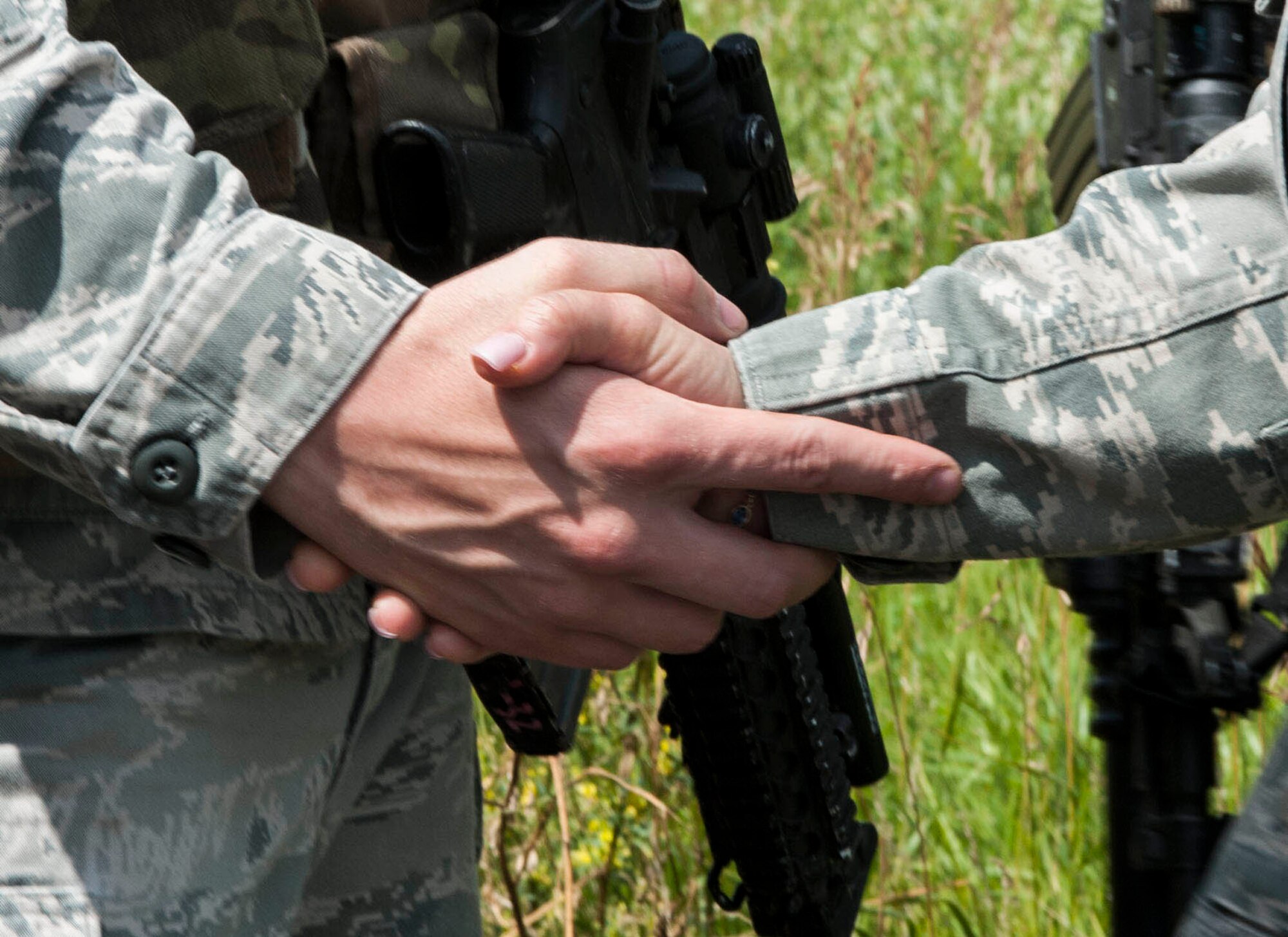 Chief Master Sgt. Melissa Permar, 791st Missile Security Forces Squadron security forces manager, shakes hands with a 791st MSFS Airman, during a morale visit to the missile complex in North Dakota, July 30, 2014. “I love conducting post visits,” Permar said. “Just seeing the smiles on their faces when we walk up to visit with the troops is so rewarding. Being with my troops is the drive that keeps me going (U.S. Air Force photo/Senior Airman Stephanie Morris)