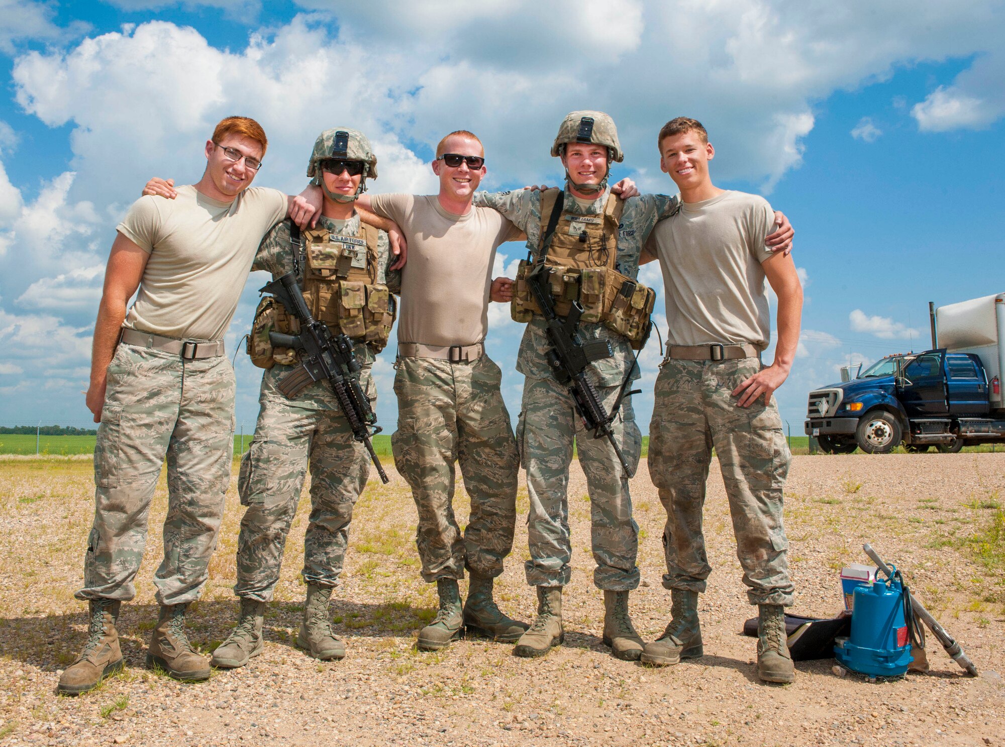 (from left to right) Airman 1st Class Alex Swarm, 91st Missile Maintenance Squadron periodic maintenance technician, Airman Jordan Link, 791st Missile Security Forces Squadron response force team member, Staff Sgt. Michael Swain 91st MMXS facility maintenance team instructor, Senior Airman Garrett Williams, 791st MSFS response force team leader and Airman 1st Class James Aita, 91st MMXS facility maintenance technician, pose for a photograph during a morale visit to the missile complex in North Dakota, July 30, 2014. 91st MSFS Airmen and 91st MMXS Airmen work side by side to ensure the safety, security and effectiveness of the nation’s assets. (U.S. Air Force photo/Senior Airman Stephanie Morris)