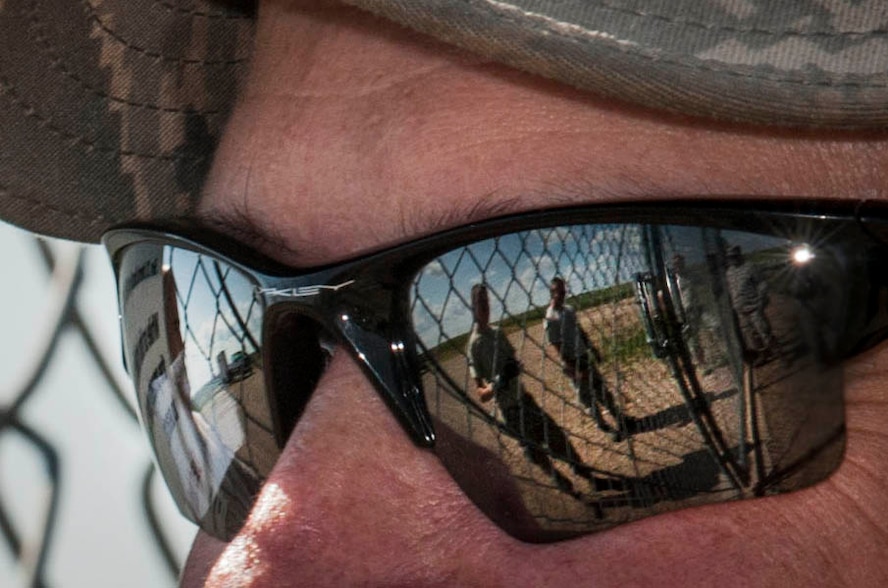 791st Missile Security Forces Squadron and 91st Missile Maintenance Squadron Airmen are reflected in the glasses of Master Sgt. Tad Wagner, 91st MMXS facility superintendent, during a morale visit to the missile complex in North Dakota, July 30, 2014. During Wagner’s last trip to the field he covered approximately 260 miles. These visits are important because leadership in both career fields can ensure the well-being of their Airmen, Wagner said.(U.S. Air Force photo/Senior Airman Stephanie Morris)