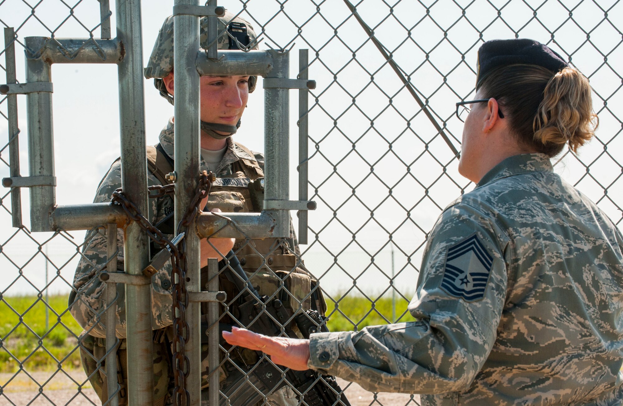 Chief Master Sgt. Melissa Permar, 791st Missile Security Forces Squadron security forces manager, speaks with Airman Nathaniel Gordon, 791st MSFS security escort team member, during a morale visit to the missile complex in North Dakota, July 30, 2014. Permar conducts morale visits approximately once a week to connect with defenders in the field and gauge their overall well-being and mission readiness. (U.S. Air Force photo/Senior Airman Stephanie Morris)