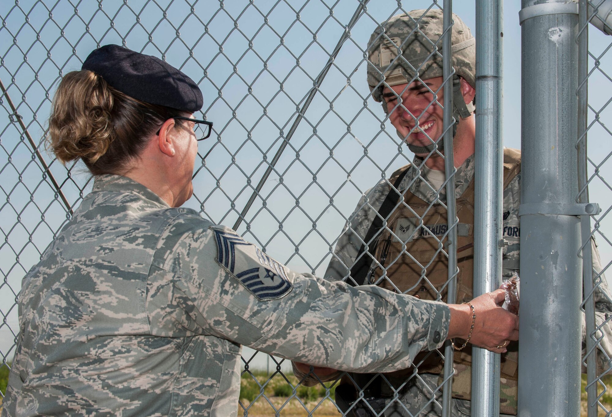 Chief Master Sgt. Melissa Permar, 791st Missile Security Forces Squadron security forces manager, talks to Senior Airman William Krausch, 791st MSFS response force leader, during a morale visit to the missile complex in North Dakota, July 30, 2014. Krausch was guarding maintenance Airmen conducting code changes at the site. (U.S. Air Force photo/Senior Airman Stephanie Morris)