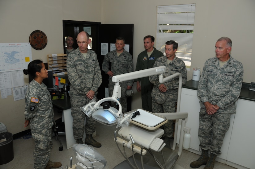 U. S. Army Maj. Tran Miller, Medical Element dentist, explains their dental capabilities on base as well as the deployable assets used during Medical Readiness Training Exercises and other humanitarian relief missions to four CAPSTONE class members .  Fifteen general and flag officers from the National Defense University's (NDU) CAPSTONE class 14-4 toured and received capability briefs from Joint Task Force-Bravo and the major support commands during their overseas field study trip to Soto Cano Air Base, Honduras, August 2, 2014.  (Photo by U. S. Air National Guard Capt. Steven Stubbs)