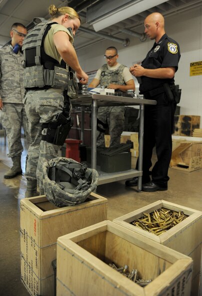 Defenders from the 71st Security Forces Squadron load their magazines before their Shoot, Move, Communicate training July 28 at the combat arms training maintenance (CATM) facility. Shoot, Move, Communicate is a mandated annual training designed for security forces Airmen to familiarize them on how to move from cover to cover in stressful situations while directing fire.  (U.S. Air Force photo/Staff Sgt. Nancy Falcon)