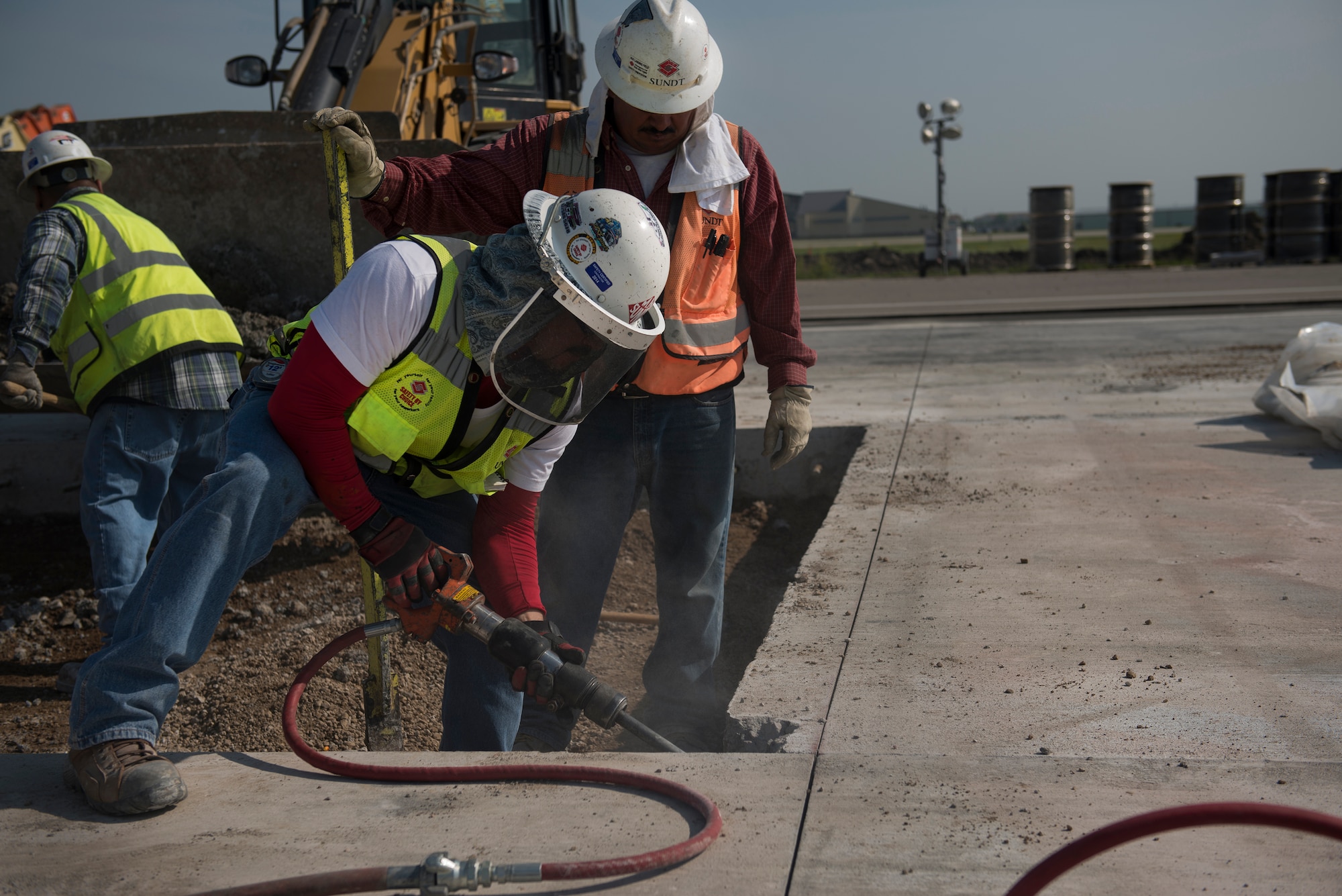 Construction on the Minot Air Force Base, N.D., flightline continues after breaking ground on the final section in April of 2014. Engineers and construction teams work to complete the concrete and asphalt pouring while checking for cracks, bumps or discrepancies in the new runway. Teams are working to complete the project before the beginning of October.  (U.S. Air Force photos/Airman 1st Class Lauren Pitts)  