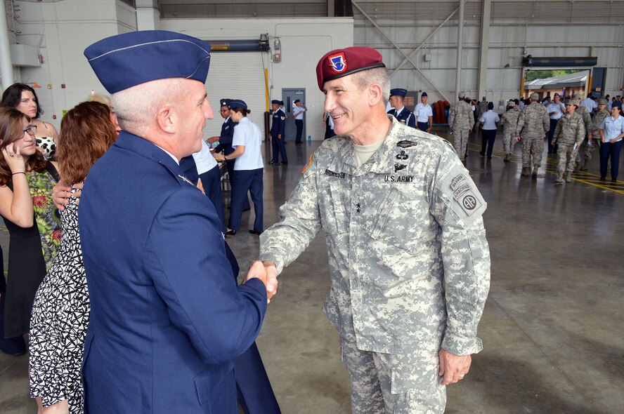 Maj. Gen. John W. Nicholson Jr., 82nd Airborne Division commanding general, congratulates Col. Kenneth E. Moss, 43rd Airlift Group commander, after Moss took command of the 43rd AG during the Group’s change of command ceremony on Aug. 5, Pope Army Airfield, N.C. Moss took command from the outgoing commander, Col. Daniel H. Tulley, who moves on to his next assignment as the commander for the 6th Air Mobility Wing, MacDill Air Force Base, Fla. (U.S. Air Force photo/Marvin Krause)