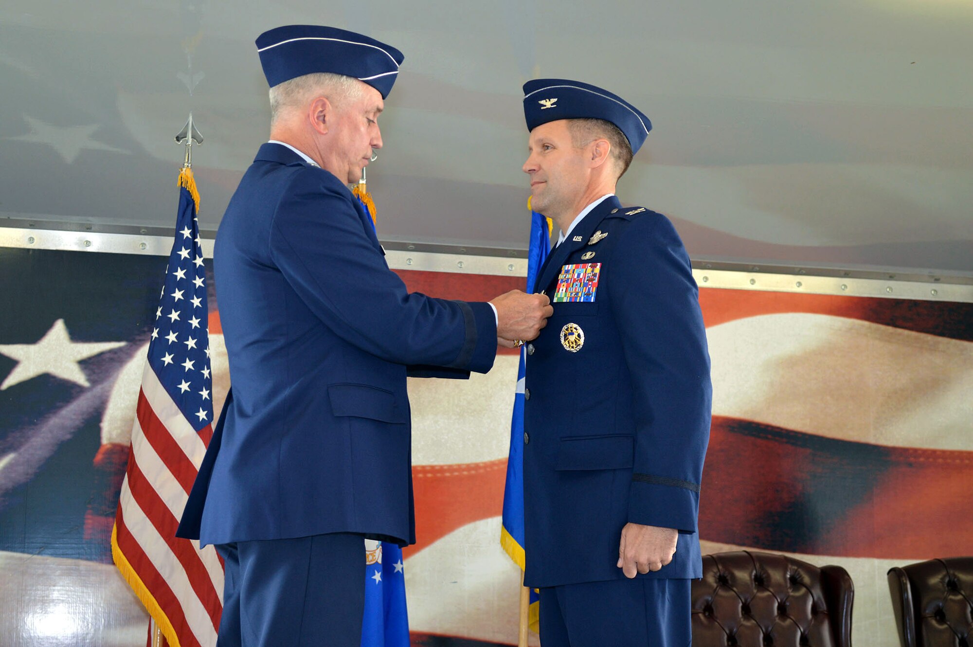 Maj. Gen. Frederick H. Martin, U.S. Air Force Expeditionary Center commander, presents the Legion of Merit medal to Col. Daniel H. Tulley, outgoing 43rd Airlift Group commander, during the group’s change of command ceremony on August 5, 2014 at Pope Army Airfield, N.C. During Tulley’s command, the 43rd AG’s “Gryphons” executed over 4,000 Joint Special Operations Command, Army and Air Force contingency missions with a 99 percent departure reliability rate. Tulley has commanded the 43rd AG since July 2012 and moves on to his next assignment as commander of the 6th Air Mobility Wing, MacDill Air Force Base, Fla. (U.S. Air Force photo/Marvin Krause)