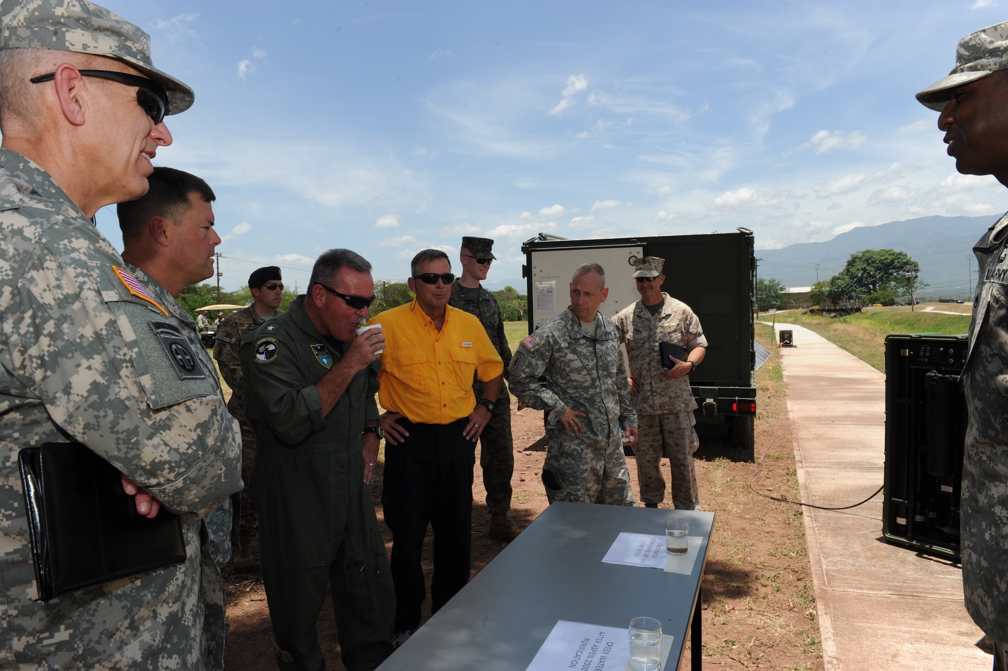 U. S. Navy Rear Adm.Daniel H. Fillion, Director of Strategy, Policy, & Plans for
US Southern Command, samples water that has been purified using the Pre-Positioned Expeditionary Assistance Kit (PEAK) which provides drinking water from local sources, power from renewable sources and communication services during a humanitarian assistance/disaster relief operation.  Fifteen general and flag officers from the National Defense University's (NDU) CAPSTONE class 14-4 toured and received capability briefs from Joint Task Force-Bravo and the major support commands during their overseas field study trip to Soto Cano Air Base, Honduras, August 2, 2014.  (Photo by Martin Chahin)