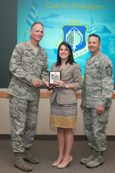 HANSCOM AIR FORCE BASE, Mass. -- Col. Michael A. Vogel, 66th Air Base Group commander, presents Cali M. Rodriquez, C3I and Networks Directorate program manager, a plaque after her announcement as the Civilian Category II of the Quarter winner at the Hanscom Conference Center Aug. 1. More than 40 nominees were nominated from organizations across Hanscom AFB this quarter. (U.S. Air Force photo by Mark Herlihy)