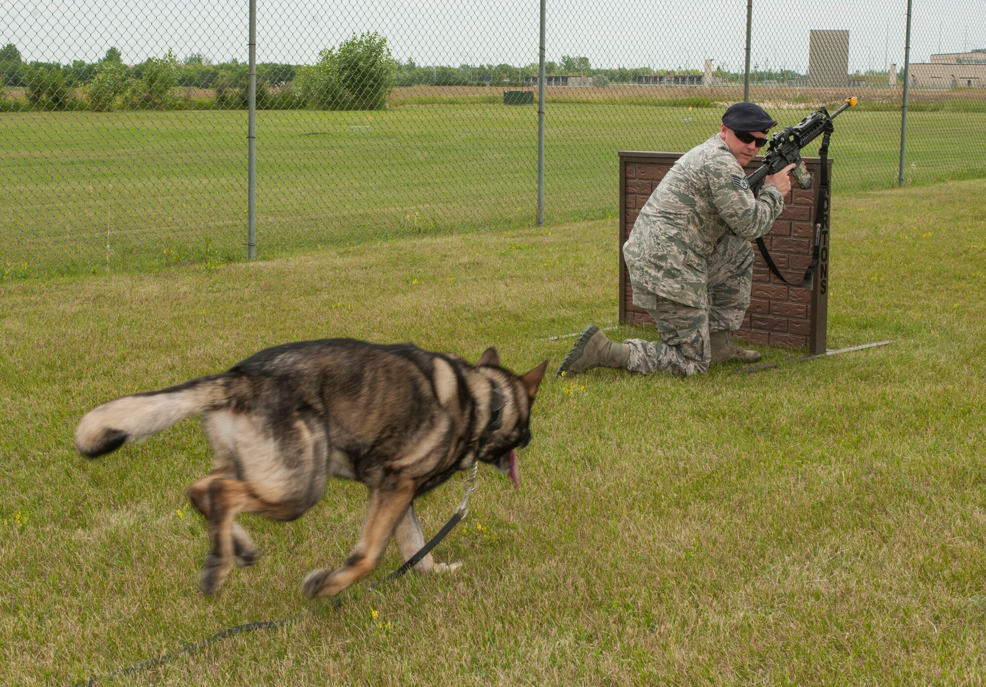 Staff Sgt. Tim Glover, 5th Security Forces Squadron military working dog handler, calls his MWD Roko to him during weapons training on Minot Air Force Base, N.D., July 28, 2014. After watching MWD handlers work at his last base, Glover decided he wanted to specialize and applied to become one. (U.S. Air Force photo/Senior Airman Stephanie Morris)