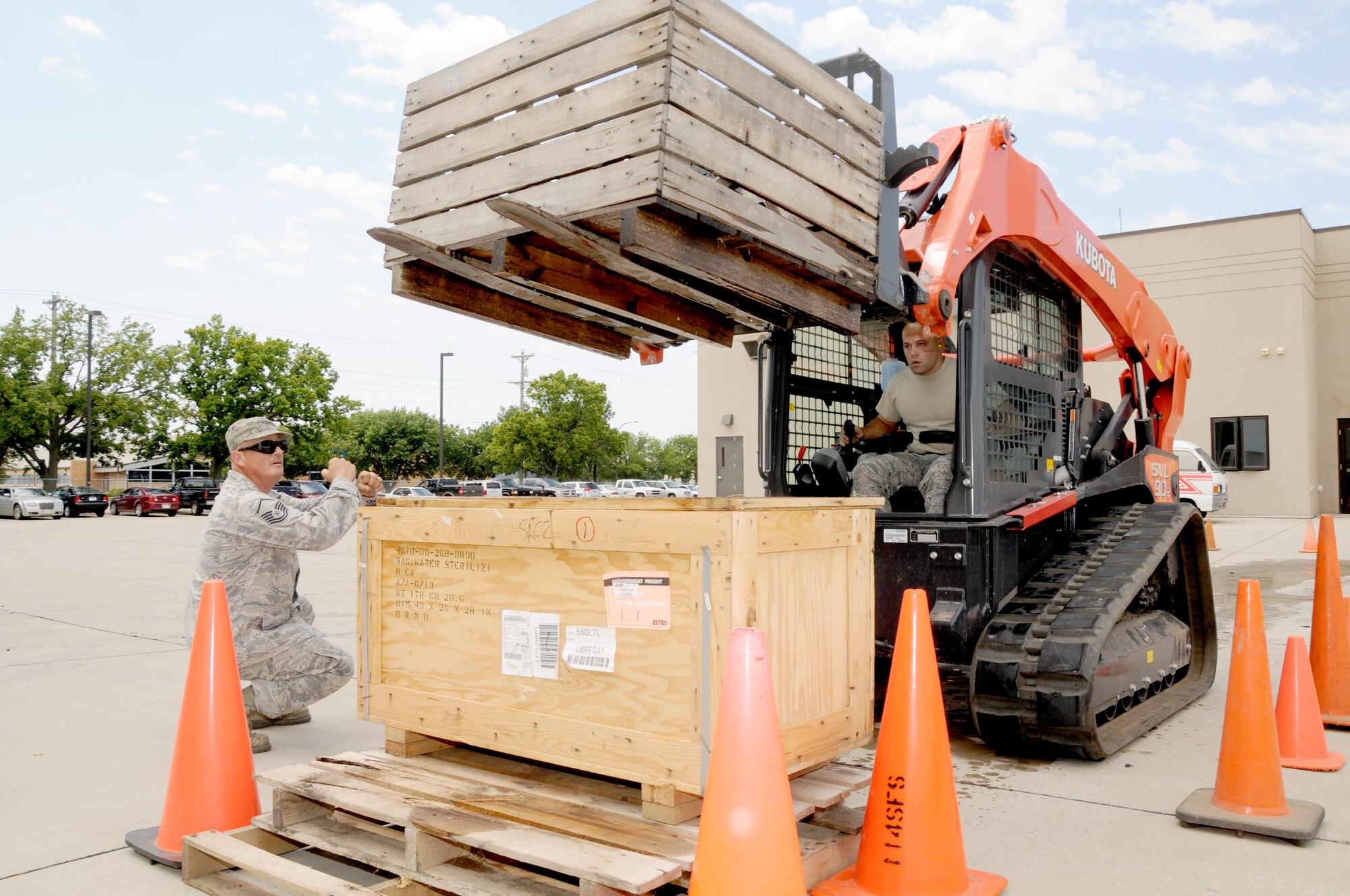 Master Sgt. Dennis Stoffel, 114th Civil Engineer Squadron NCOIC Pavements and Equipment, directed Tech. Sgt. Zachary Jorgensen, 114th Civil Engineer Squadron HVAC Superintendent, during a tracked skid loader rodeo held at Joe Foss Field S,D. August 2, 2014.  The rodeo was one of several activities conducted during a safety down day that reinforced proper safety procedures and precautions.(National Guard photo by Tech. Sgt. Christopher Stewart/Released)