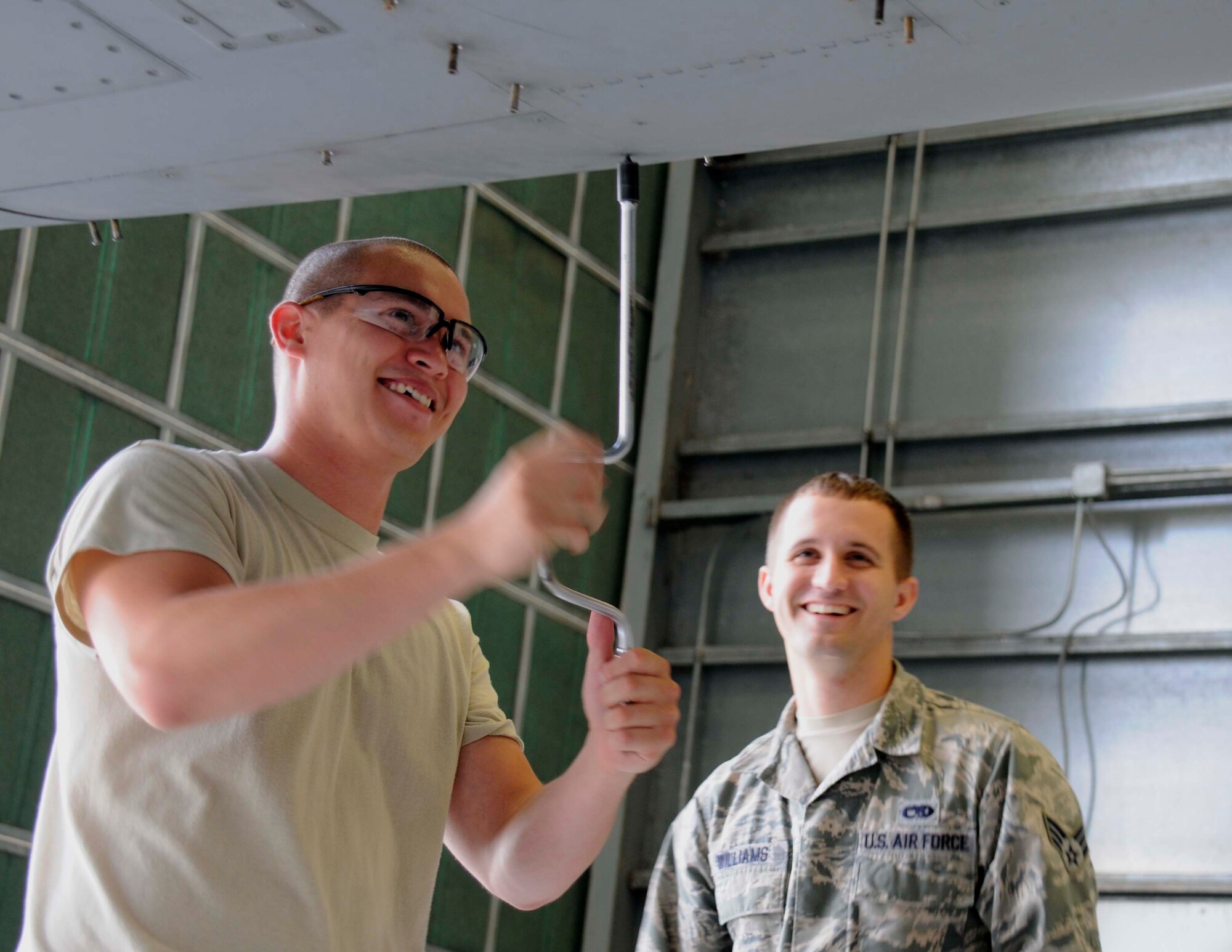 Senior Airman Thomas Marabillas, tactical aircraft maintenance technician, 482nd Aircraft Maintenance Squadron and Senior Airmen Jacob Williams 495th Fighter Group, Detachment 93, installing the panels of an F-16C at Homestead Air Reserve Base, Fla. Aug. 4. These Airmen are a part of the Total Force Integration detachment that trains active-duty and reserve Airmen together. (U.S. Air Force photo by/Senior Airman Aja Heiden) 