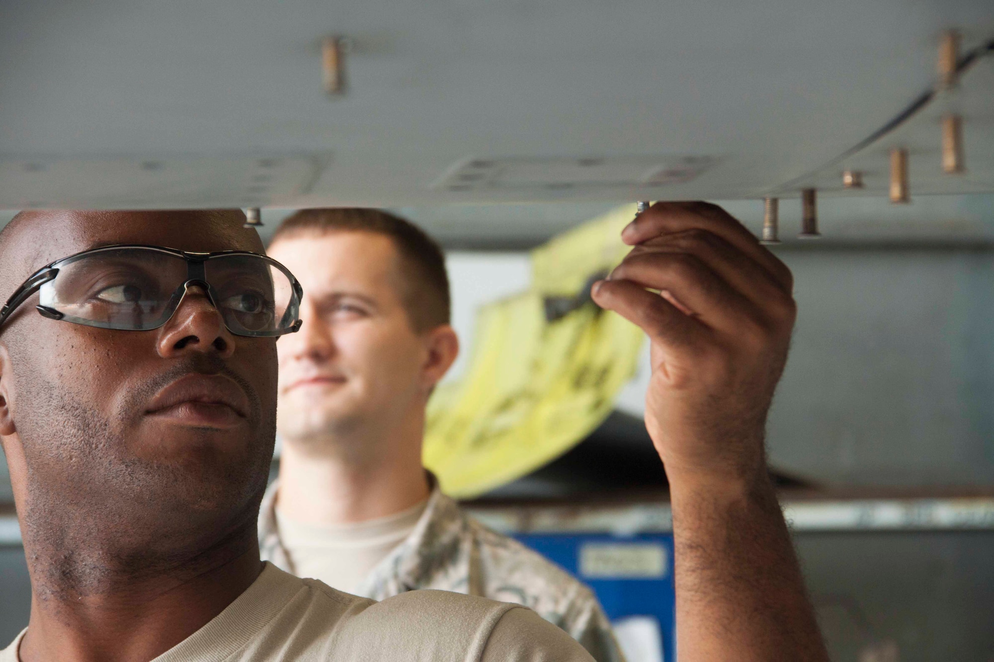 Senior Airman Kevin Carlisle, a tactical aircraft maintenance technician for the 482nd Aircraft Maintenance Squadron, and Senior Airman Jacob Williams, a tactical aircraft maintenance technician for the 495th Fighter Group, Detachment 93, work together to install a panel on an F-16C aircraft at Homestead Air Reserve Base, Fla. Aug. 4. These Airmen are a part of a Total Force Integration detachment that trains active-duty and reserve Airmen together. (U.S. Air Force photo by/Senior Airman Jaimi L. Upthegrove) 