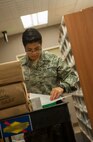 Staff Sgt. Martha Lopez, 5th Medical Support Squadron pharmacy technician, checks orders on Minot Air Force Base, N.D., July 30, 2014. In fiscal year 2013, the pharmacy had a record-high prescription volume. (U.S. Air Force photo/Airman 1st Class Apryl Hall)