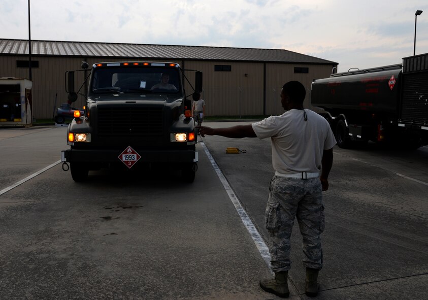 U.S. Air Force Airman 1st Class Wallis Iduoze, 23d Logistics Readiness Squadron petroleum, oil and lubricants flight fuel distribution operator, performs a light check a during daily truck inspection Aug. 1, 2014, at Moody Air Force Base, Ga. POL Airmen ensure mission readiness at all times by maintaining their own equipment and providing clean fuel through samples and tests. (U.S. Air Force photo by Staff Sgt. Eric Summers Jr./Released)