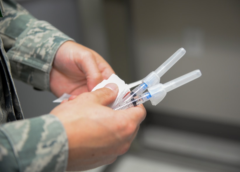 U.S. Air Force Staff Sgt. Matthew Scully, 38th Rescue Squadron independent duty medical technician, prepares to vaccinate a patient at Moody Air Force Base, Ga., July 30, 2014. Scully provides medical treatment for the 38th RQS in austere environments during deployments and other temporary duty assignments. (U.S. Air Force photo by Airman 1st Class Sandra Marrero/Released)
