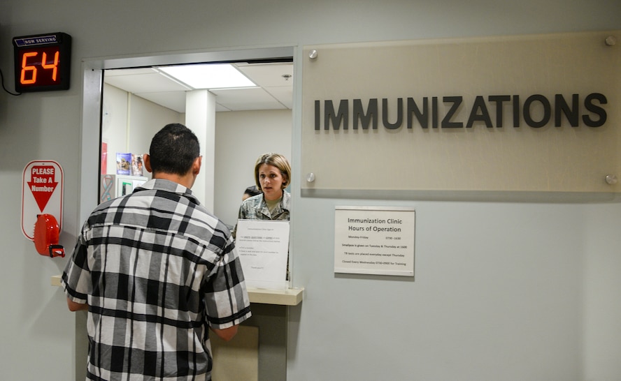 U.S. Air Force Staff Sgt. Cynthia Reichardt, 23d Medical Operations Squadron NCO in charge of allergy and immunizations, greets Staff Sgt. Christopher White, 23d Security Forces Squadron response force leader, at Moody Air Force Base, Ga., July 30, 2014. The base immunizations clinic administered 19,517 vaccines last fiscal year. (U.S. Air Force photo by Airman 1st Class Sandra Marrero/Released)
