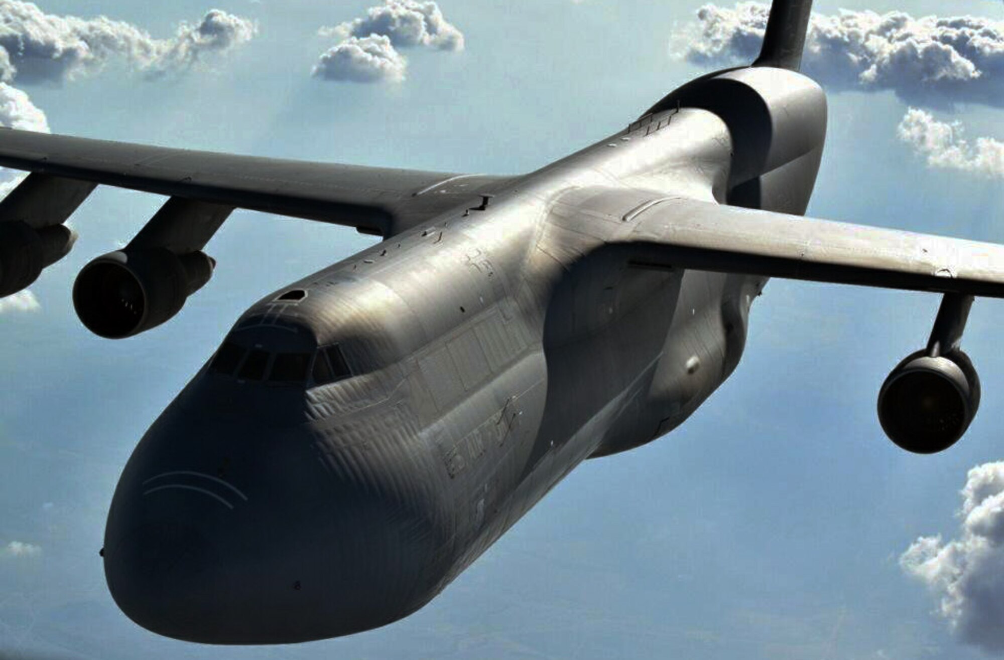 A C-5 Galaxy assigned to the Air Force Reserve 433rd Airlift Wing, Joint Base San Antonio, Texas, flies behind a KC-135 Stratotanker from McConnell Air Force Base, Kan., during an air refueling training exercise, Aug. 5, 2014.  The KC-135 was operated by an aircrew made up of reservists from the 931st Air Refueling Group at McConnell.  The 931 ARG regularly supports air refueling training for new C-5 pilots who are attending training at the Formal Training Unit (FTU) at Joint Base San Antonio.  (U.S. Air Force photo by Senior Master Sgt. Brad Beyer)