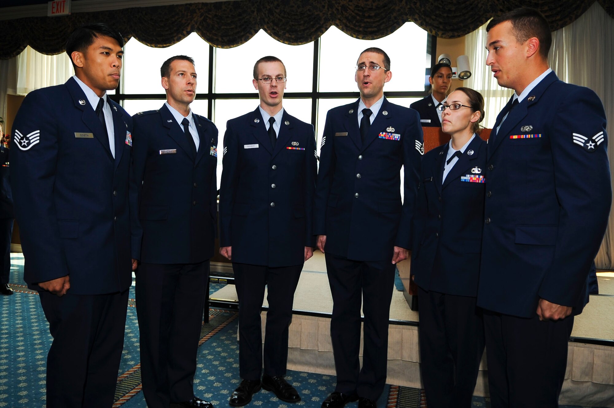 The "Stripes with Pipes" choir group performs at the 497th Operational Support Squadron change of command at Langley Air Force Base, Va., July 15, 2014. The Stripes formed under the direction of U.S. Air Force Staff Sgt. Aaron Bigler, 10th Intelligence Squadron security manager, as a morale booster and outlet for creative singing. (U.S. Air Force photo by Senior Airman Austin Harvill/Released)