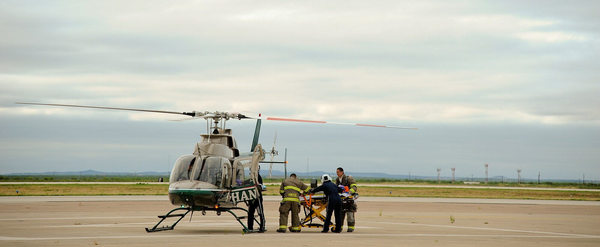 SAN ANGELO, Texas – San Angelo Fire Department and Shannon Medical Center’s AirMed1 personnel prepare to lift a plane crash victim into a helicopter during a military and civilian joint training exercise at Mathis Field July 31. Goodfellow Air Force Base worked with San Angelo Police and Fire Department, Shannon and Community medical centers, and Mathis Field airport officials in the training exercise. (U.S. Air Force photo/ Airman 1st Class Devin Boyer)