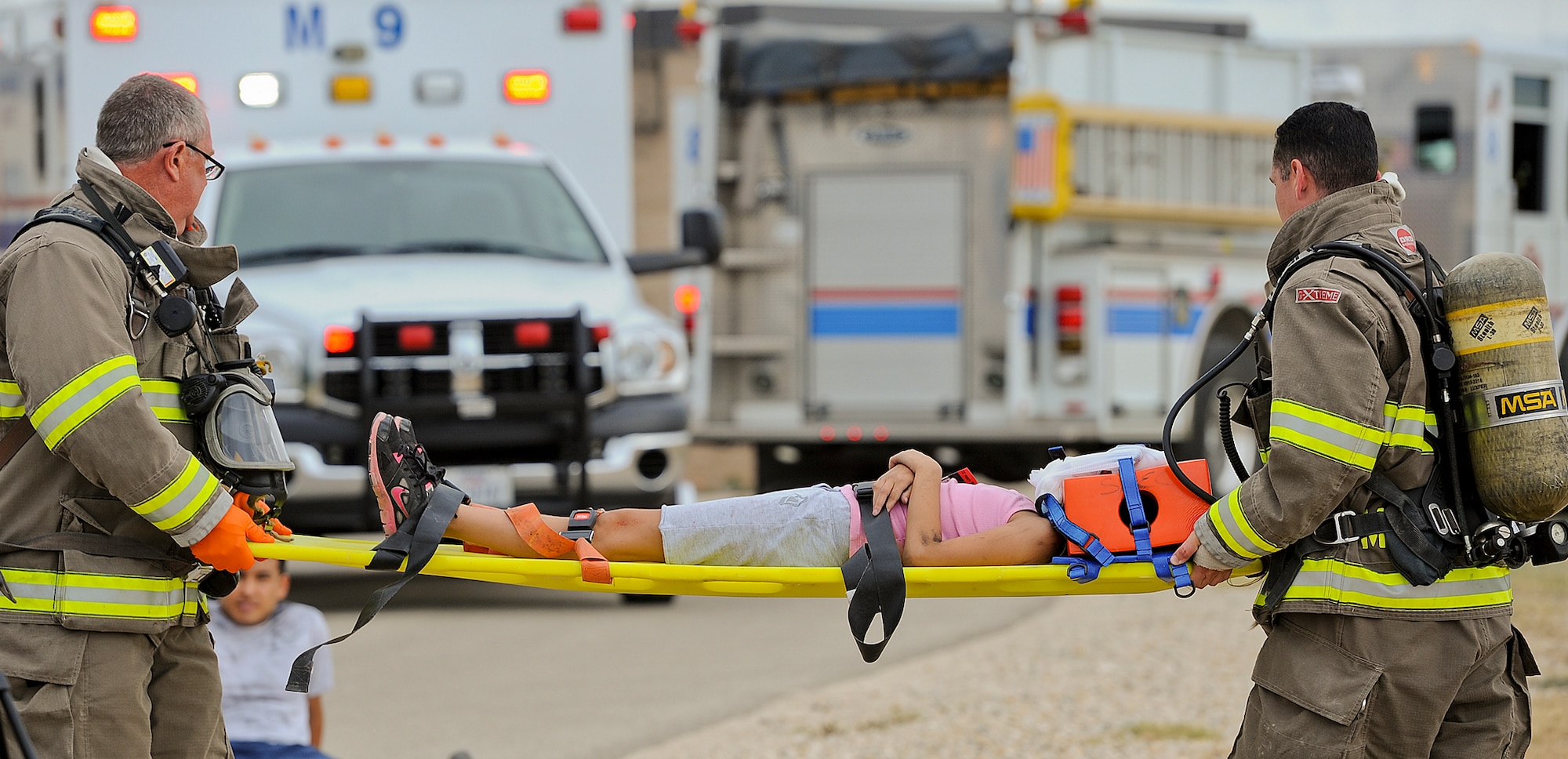 SAN ANGELO, Texas – San Angelo Fire Department personnel carry a simulated plane crash victim during a military and civilian joint training exercise at Mathis Field July 31. The training exercise, named Scarlet Hawk 1403, was a simulation of a plane crash that resulted in 52 casualties. (U.S. Air Force photo/ Airman 1st Class Devin Boyer)