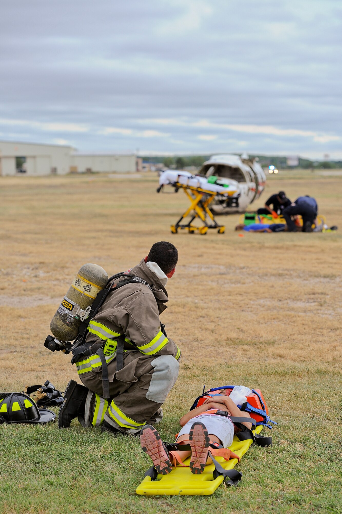 SAN ANGELO, Texas – First responders assess and treat injuries during a military and civilian joint training exercise at Mathis Field July 31. The goal of the exercise was to test response times for Goodfellow Air Force Base, city agencies and airport officials. (U.S. Air Force photo/ Airman 1st Class Devin Boyer)