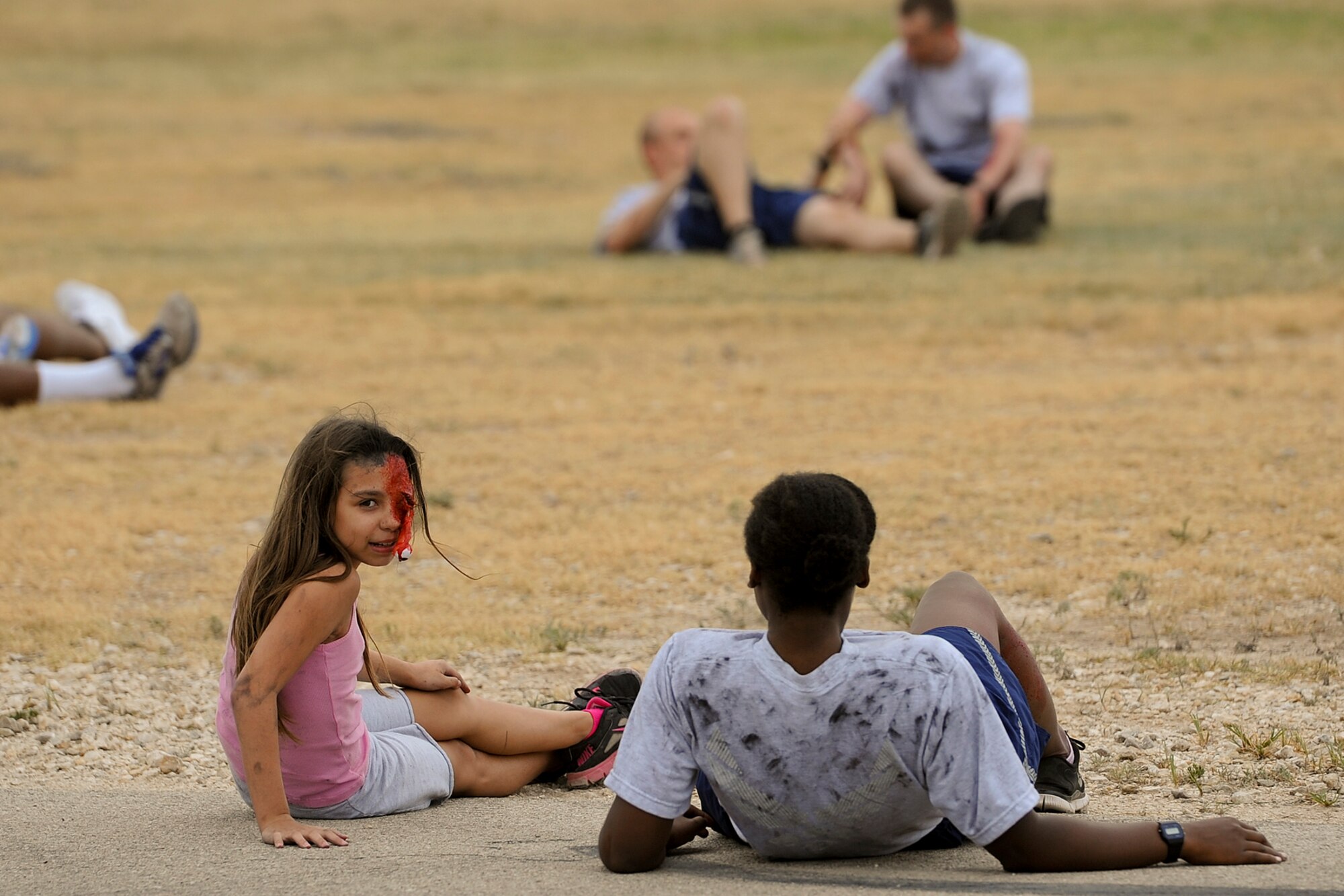 SAN ANGELO, Texas – Volunteer victims wait for first responders during a military and civilian joint training exercise at Mathis Field July 31. The volunteers wore moulage to simulate injuries that may have occurred in the plane crash. (U.S. Air Force photo/ Airman 1st Class Devin Boyer)