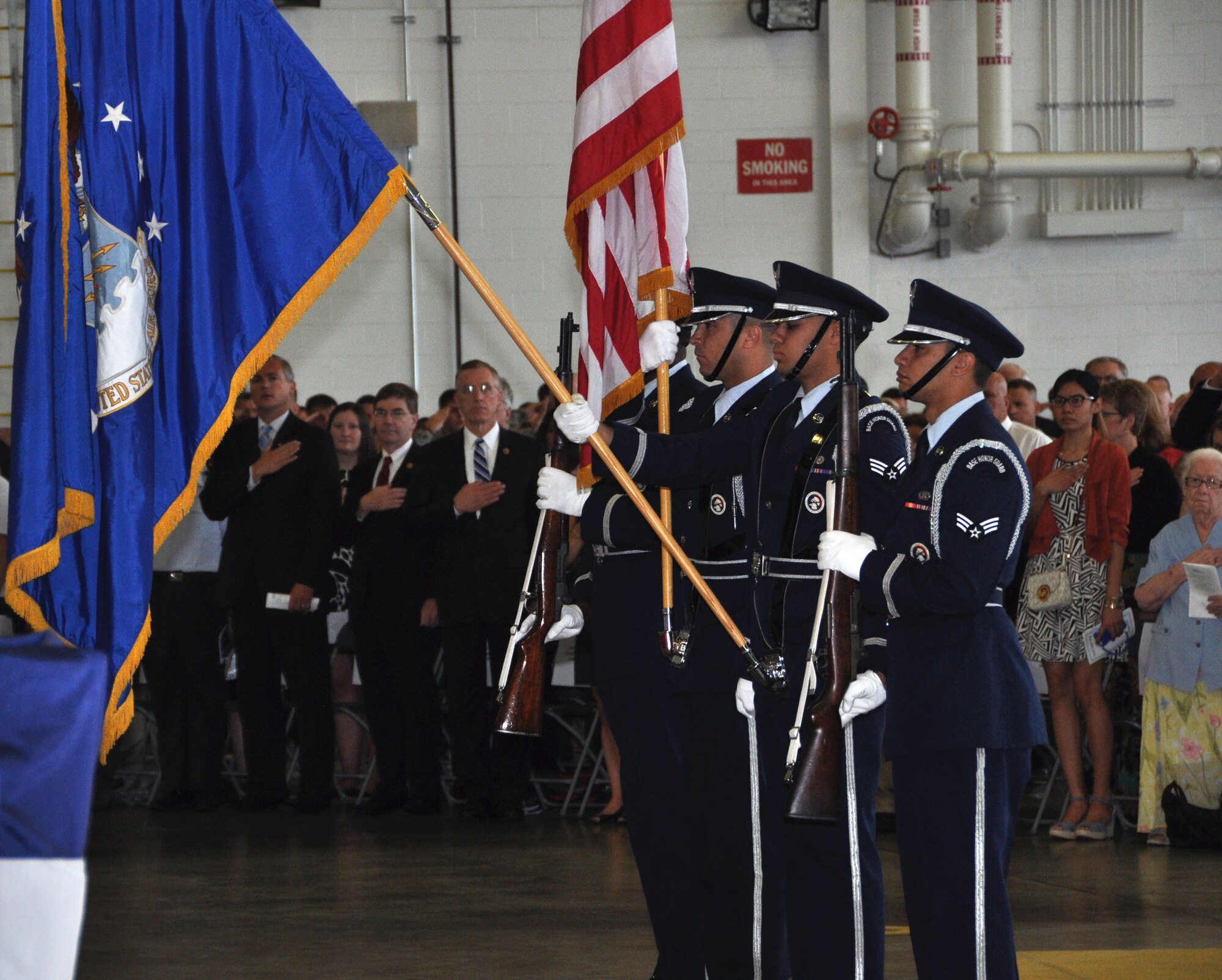 Members of the 911th Airlift Wing Honor Guard stand at the position of present arms during the singing of the national anthem during the Change of Command ceremony at the Pittsburgh International Airport Air Reserve Station, Aug. 3, 2014. (U.S. Air Force photo by Staff Sgt. Brandy Grace)