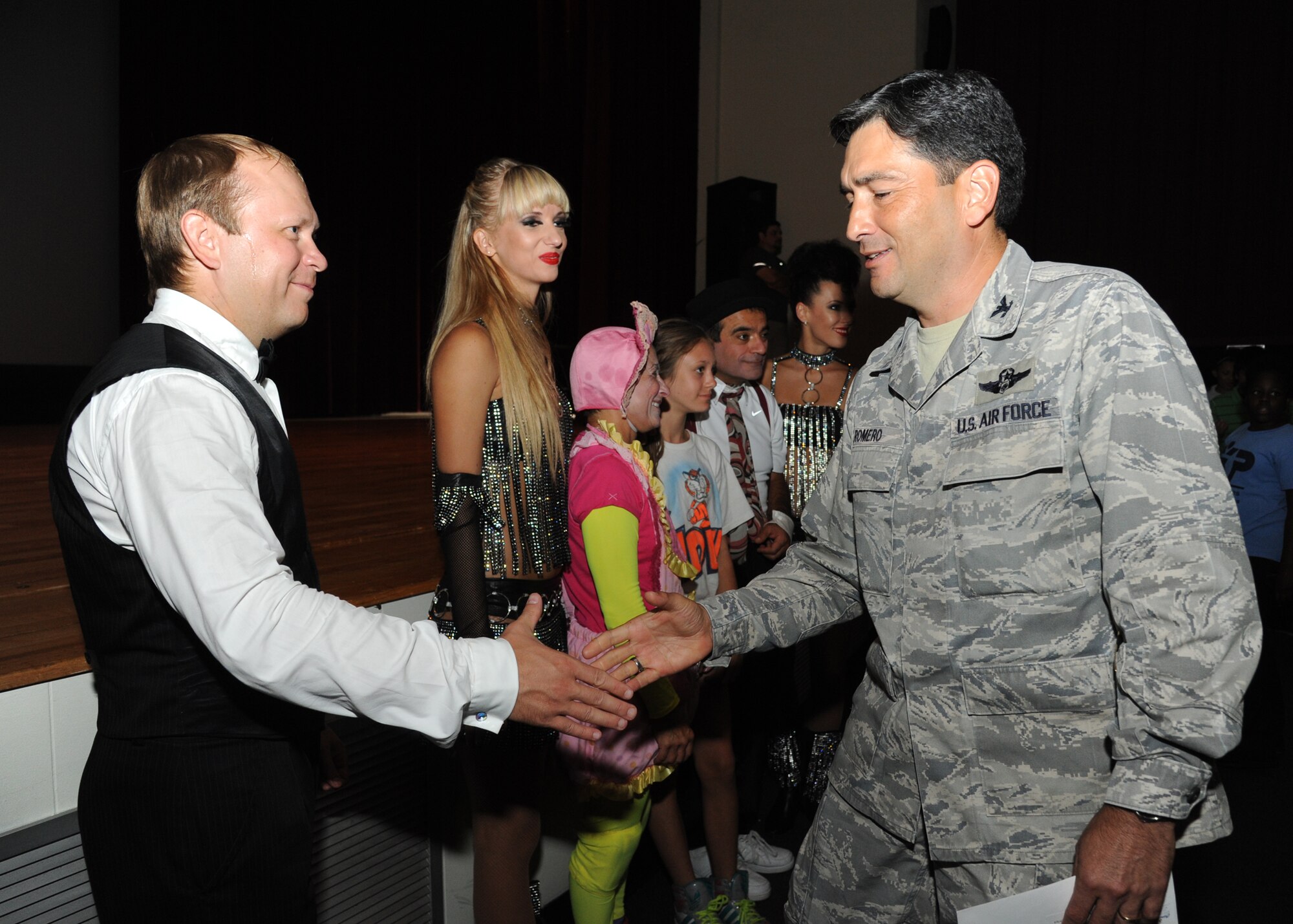 Saltoriya performers receive handshakes from Col. René Romero, 81st Training Wing vice commander, following a military appreciation show Aug. 1, 2014, at the Welch Theater, Keesler Air Force Base, Miss.  Saltoriya features some of the best international aerialists and artists who perform gravity-defying feats. (U.S. Air Force photo by Kemberly Groue)