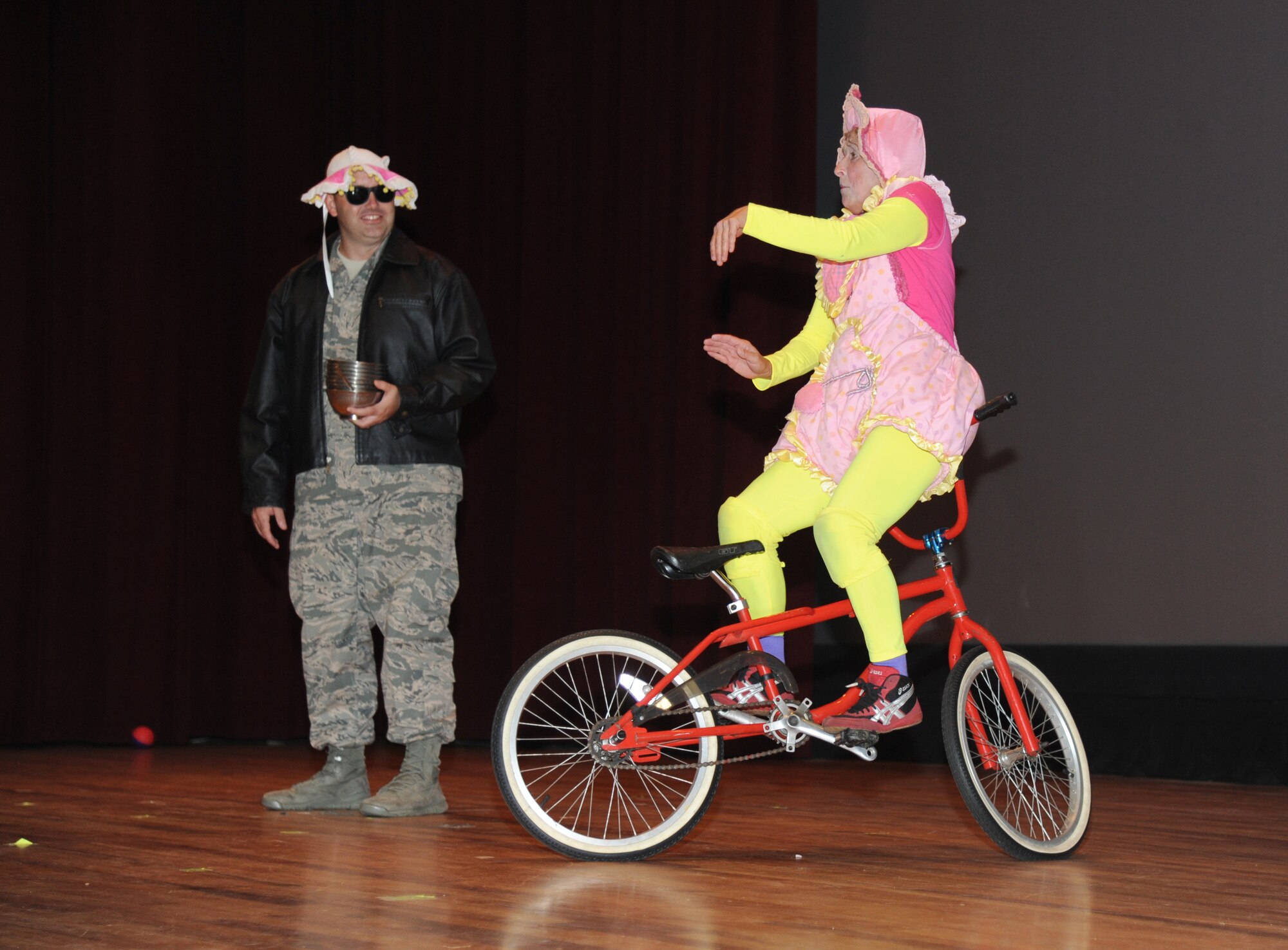 Master Sgt. Robert Kesler, 81st Force Support Squadron, assists a Saltoriya performer, who portrays a wandering baby, during a military appreciation show Aug. 1, 2014, at the Welch Theater, Keesler Air Force Base, Miss.  Saltoriya features some of the best international aerialists and artists who perform gravity-defying feats. (U.S. Air Force photo by Kemberly Groue)