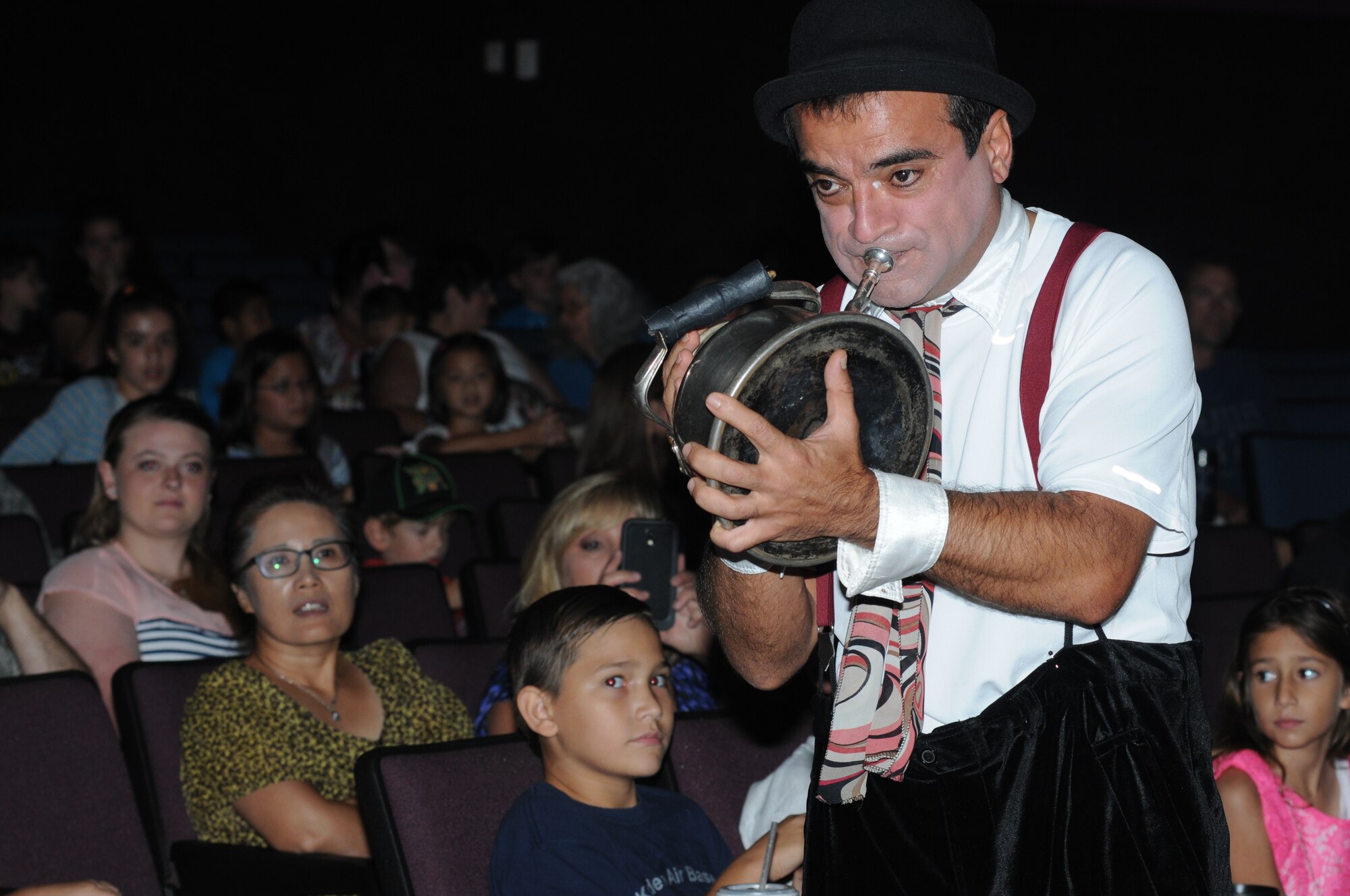 A Saltoriya performer plays music with a tea pot during a military appreciation show Aug. 1, 2014, at the Welch Theater, Keesler Air Force Base, Miss.  Saltoriya features some of the best international aerialists and artists who perform gravity-defying feats. (U.S. Air Force photo by Kemberly Groue)