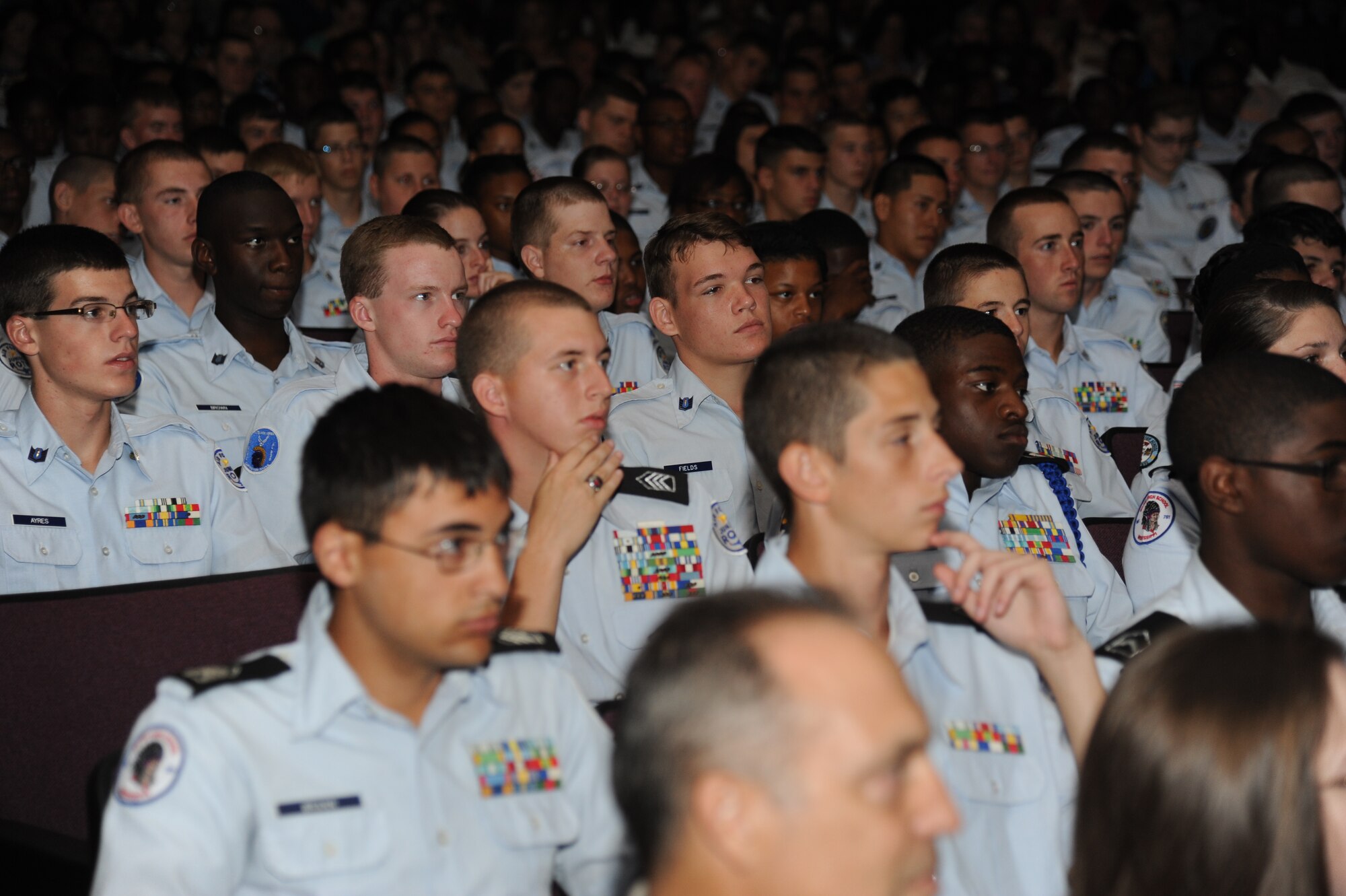 JROTC cadets listen to the guest speaker during a graduation ceremony Aug. 1, 2014, at the Welch Theater, Keesler Air Force Base, Miss.  Approximately 100 JROTC students from seven states attended a week-long JROTC Summer Leadership School at Keesler that ended with a parade and a graduation ceremony at the Welch Theater. (U.S. Air Force photo by Kemberly Groue)