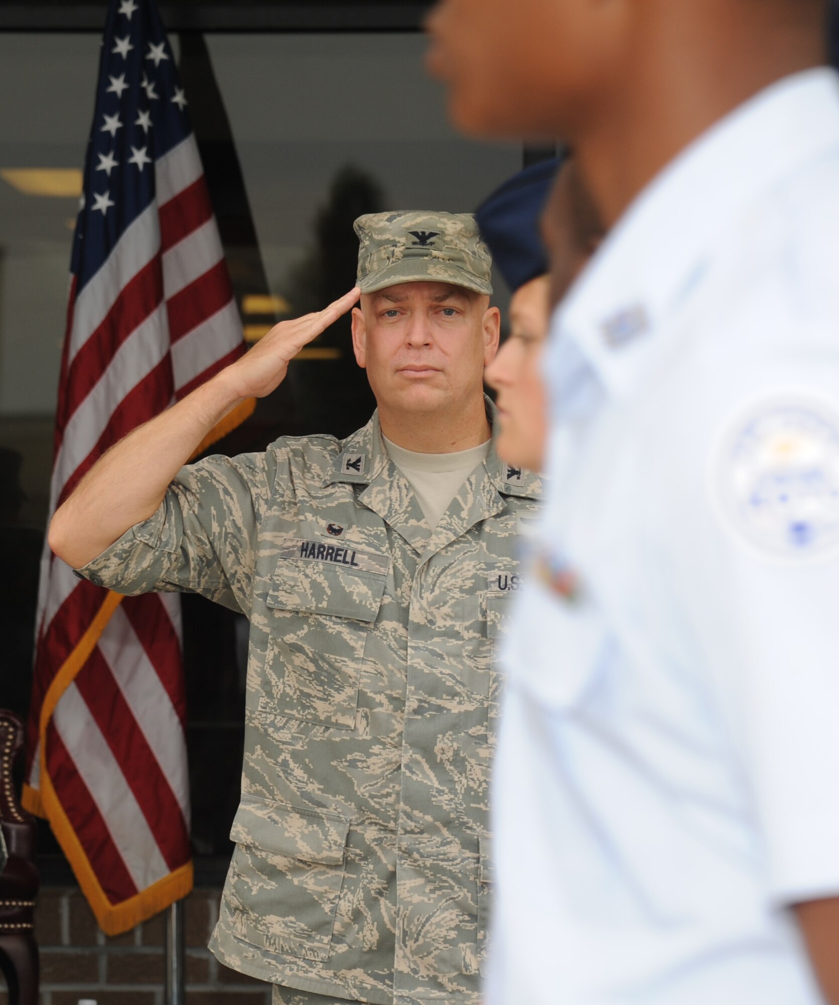 Col. Thomas Harrell, 81st Medical Group commander, salutes JROTC cadets as they pass in formation during a parade Aug. 1, 2014, at the Levitow Training Support Facility, Keesler Air Force Base, Miss.  Approximately 100 JROTC students from seven states attended a week-long JROTC Summer Leadership School at Keesler that ended with the parade and a graduation ceremony at the Welch Theater. (U.S. Air Force photo by Kemberly Groue)