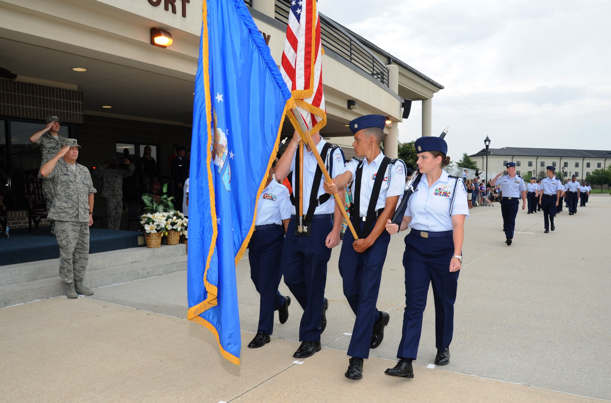 Chief Master Sgt. Michael Wood, 81st Medical Group superintendent, and Col. Thomas Harrell, 81st MDG commander, salute JROTC cadets as they pass in formation during a parade Aug. 1, 2014, at the Levitow Training Support Facility, Keesler Air Force Base, Miss.  Approximately 100 JROTC students from seven states attended a week-long JROTC Summer Leadership School at Keesler that ended with the parade and a graduation ceremony at the Welch Theater. (U.S. Air Force photo by Kemberly Groue)
