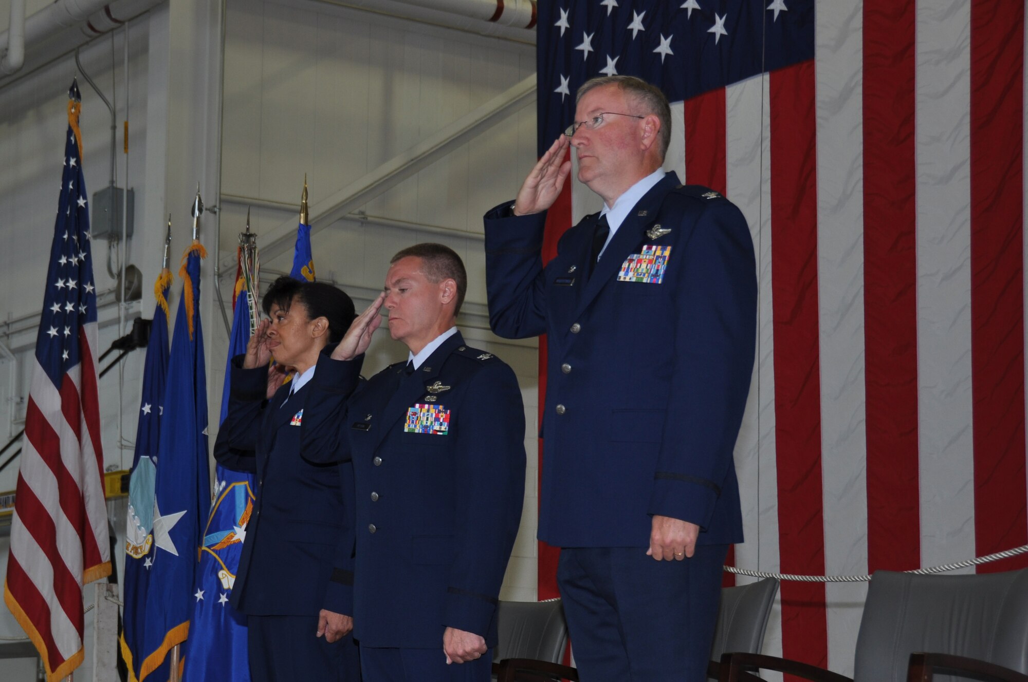Maj. Gen. Stayce D. Harris, Col. Craig C. Peters and Col. Jeffrey Van Dootingh salute the flag during the playing of the national anthem during the Change of Command ceremony at the Pittsburgh International Airport Air Reserve Station, Aug. 3, 2014. (U.S. Air Force photo by Senior Airman Marjorie Bowlden)