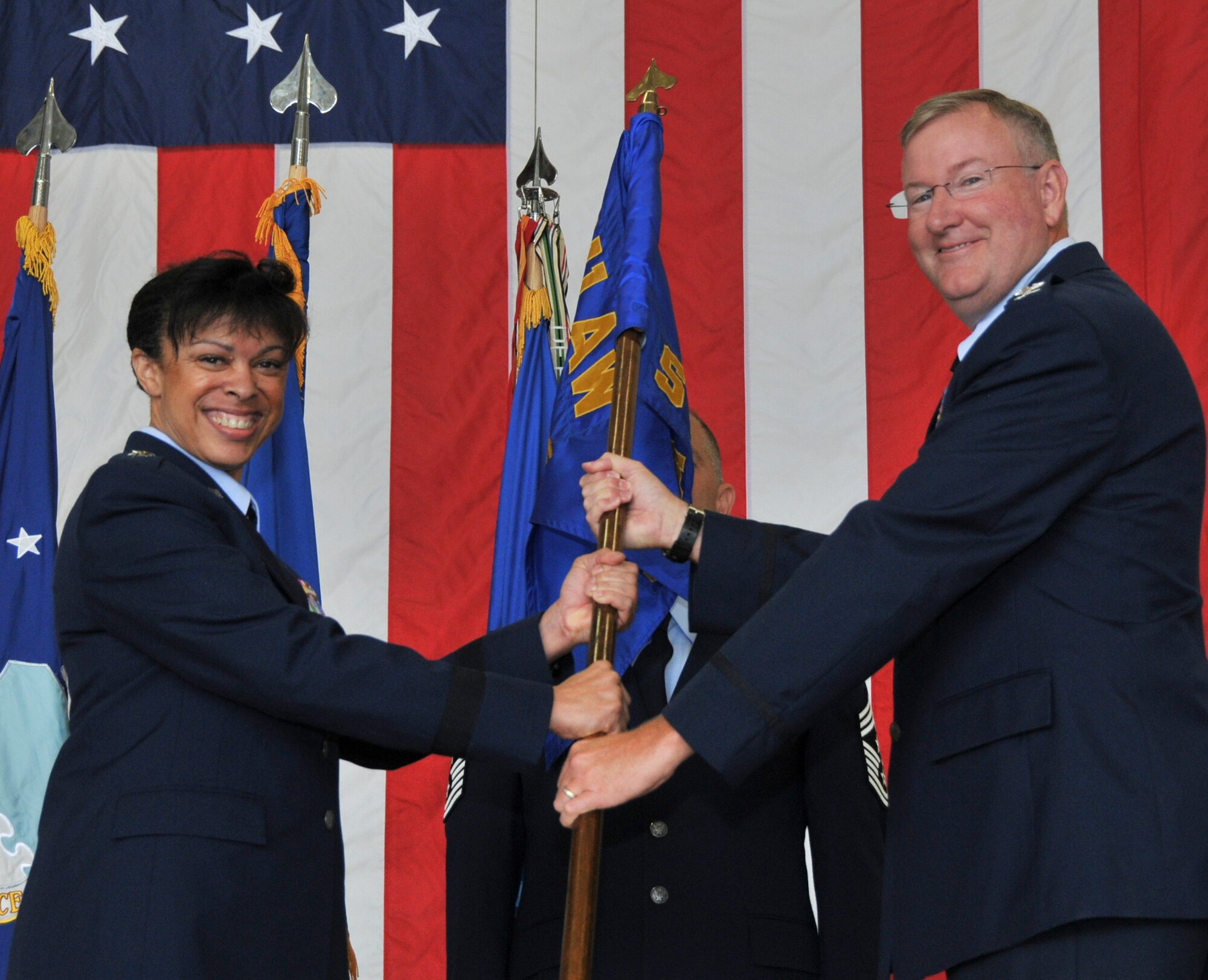 Maj. Gen. Stayce D. Harris, 22nd Air Force commander, presents Col. Jeffrey A. Van Dootingh with the 911th Airlift Wing ceremonial guidon as he assumes command in front of the Wing, family, friends, elected officials and community partners, Aug. 3, 2014. (U.S. Air Force photo by Senior Airman Justyne Obeldobel)