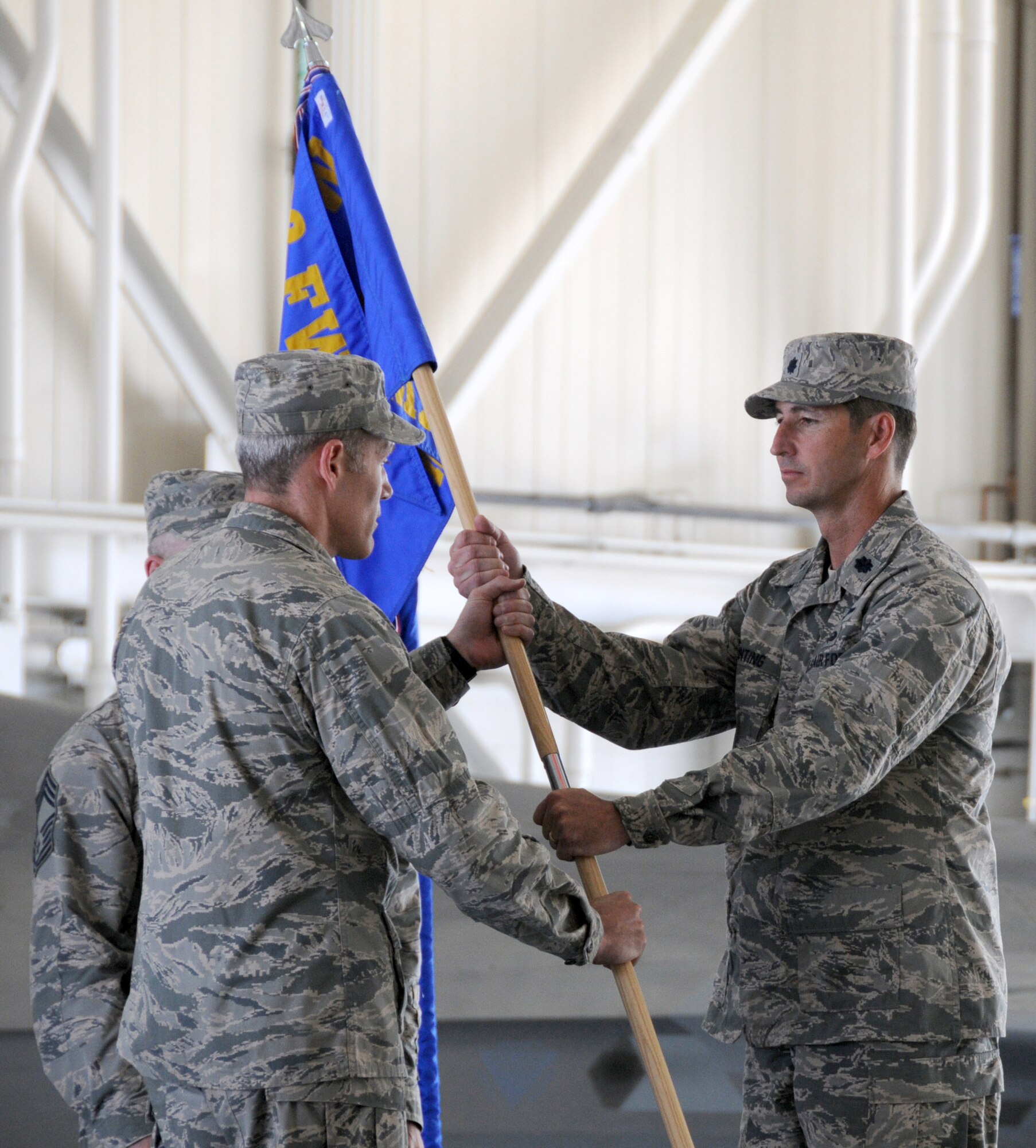 U.S. Air Force Col. Robert. J. Grey, 192nd Fighter Wing commander, presents the 192nd Maintenance Group colors to Lt. Col. Stephen H. Bunting to signify his assumption of command of the 192nd MXG, during a change of command ceremony held July 13, 2014 at Joint Base Langley-Eustis (U.S. Air National Guard photo by Master Sgt. Carlos Claudio/Released)