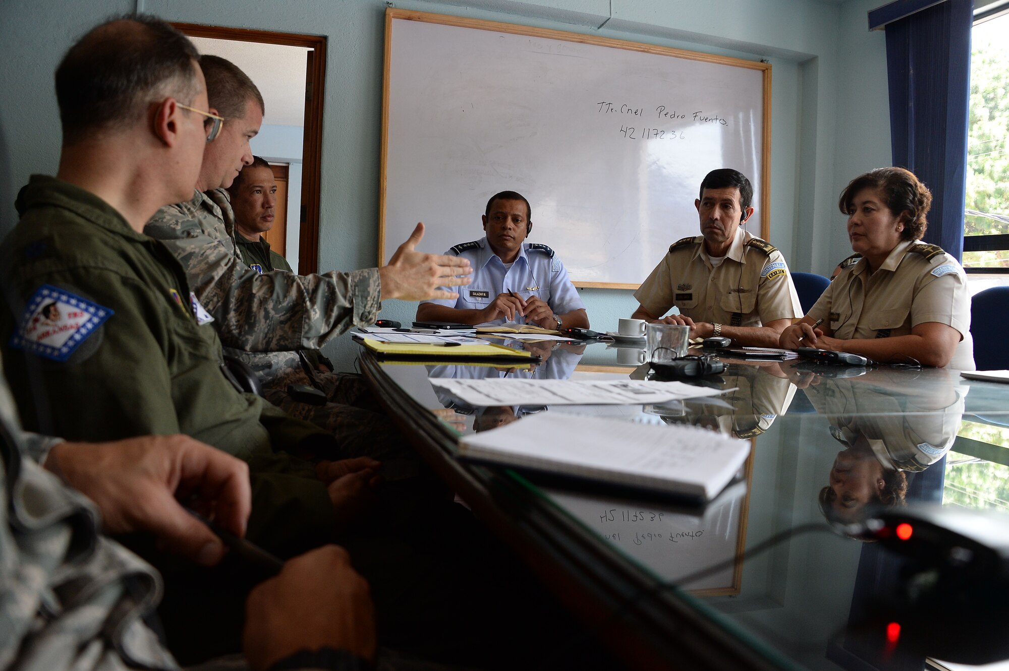 Members from the Guatemalan air force, Arkansas Air National Guard, and 12th Air Force (Air Forces Southern) discuss their goals during a subject matter expert exchange in Guatemala City, Guatemala, Aug. 4, 2014.  Goals focused on educating the Guatemalan air force on individual readiness and establishing standards for flight medicine.  (U.S. Air Force photo by Tech. Sgt. Heather R. Redman/Released) 