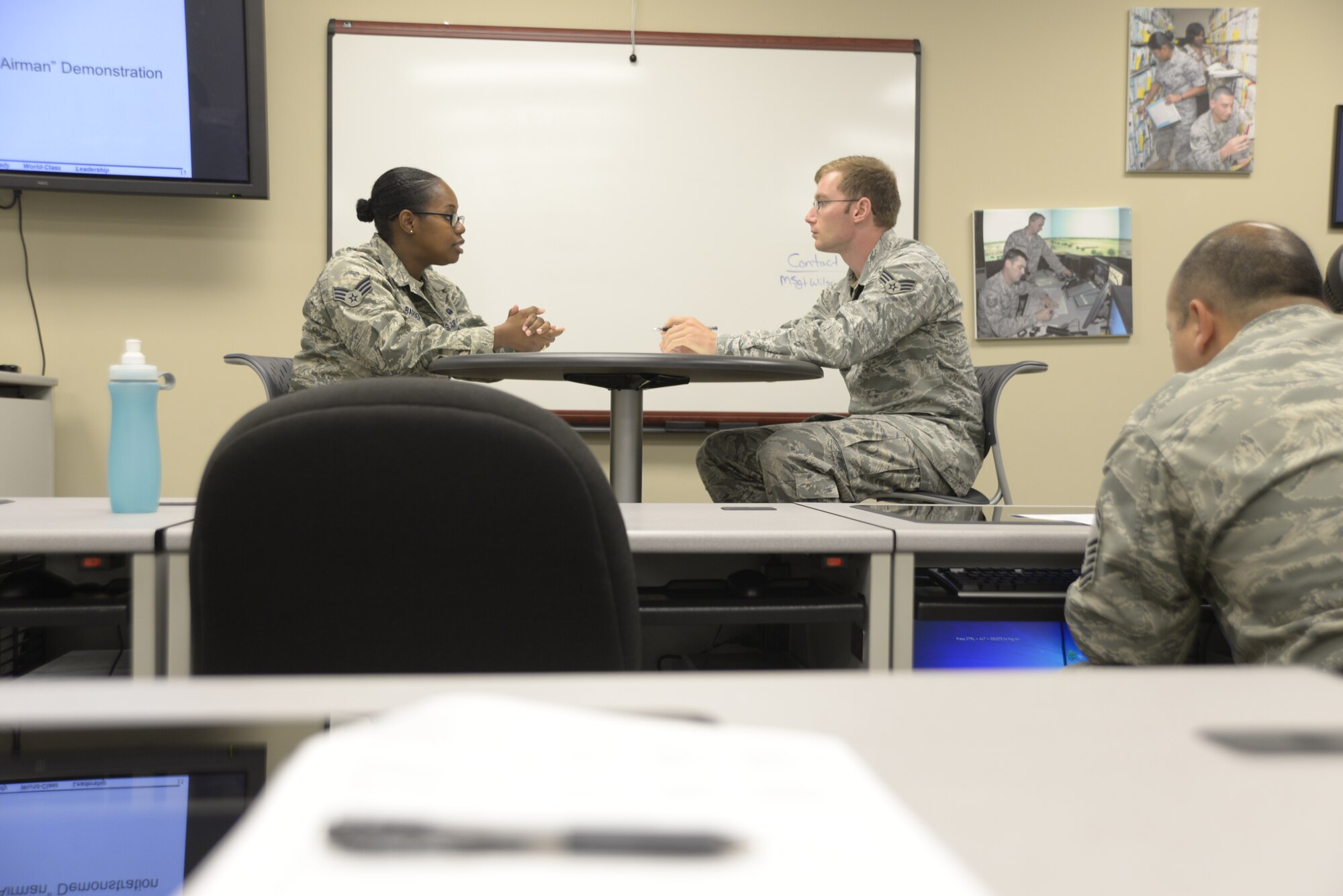 Senior Airman Sachel Barber, left, 42nd Communications Squadron, and Senior Airman Joshua Goodpaster, Air Force Life Cycle Management Flight, go over scenarios that could go come up in a feedback session using the new Airman Comprehensive Assessment form Aug. 1, 2014, at the Maxwell Professional Development Center. The center is hosting briefings and classes to help Airmen familiarize with the new form. (U.S. Air Force photo by Staff Sgt. Natasha Stannard)  