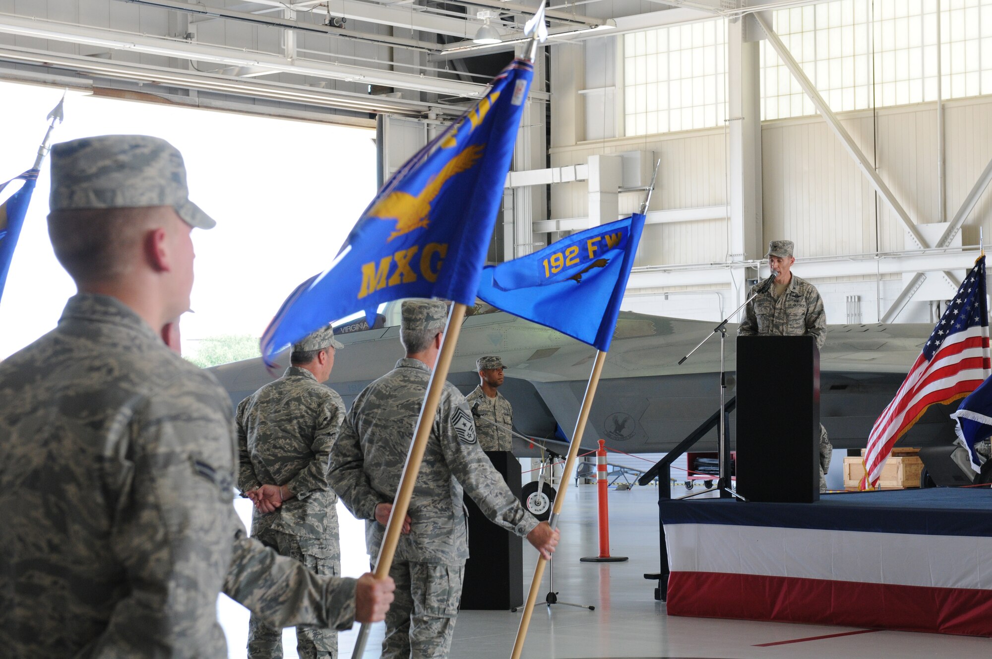 U.S. Air Force Col. Robert. J. Grey, 192nd Fighter Wing commander, presents the 192nd Maintenance Group colors to Lt. Col. Stephen H. Bunting to signify his assumption of command of the 192nd MXG, during a change of command ceremony held July 13, 2014 at Joint Base Langley-Eustis (U.S. Air National Guard photo by Tech. Sgt. Meghan Skrepenski/Released)