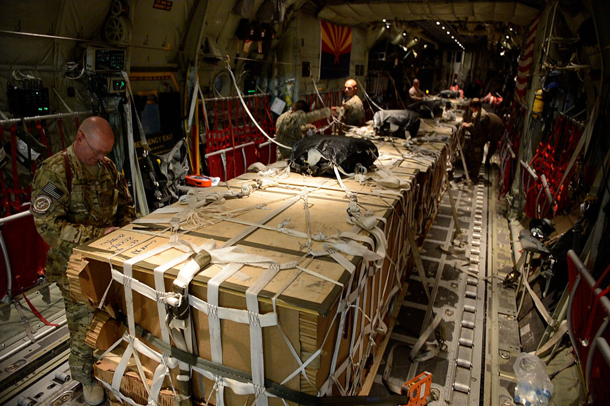 U.S. Air Force Master Sgt. Bradley Nulf, 774th Expeditionary Airlift Squadron evaluator loadmaster secures cargo for an airdrop at Bagram Airfield, Afghanistan Aug. 1, 2014.  The squadron is using the new Wireless Gate Releases System for airdrops.  The WGRS saves the Air Force in material, fuel costs and man hours. Nulf is deployed from Dyess Air Force Base, Texas and a native of Columbia City, Ind. (U.S. Air Force photo by Staff Sgt. Evelyn Chavez/Released)