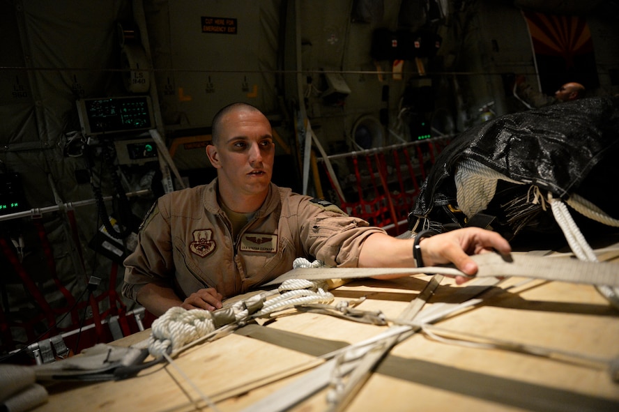 U.S. Air Force Stefan Eiermann, 774th Expeditionary Airlifit Squadron loadmaster secures cargo for an airdrop at Bagram Airfield, Afghanistan Aug. 1, 2014.  The squadron is using the new Wireless Gate Releases System for airdrops.  The WGRS saves the Air Force material, fuel costs and man hours.  Eiermann is deployed from Dyess Air Force Base, Texas and a native of Corpus Christi, Texas. (U.S. Air Force photo by Staff Sgt. Evelyn Chavez/Released)