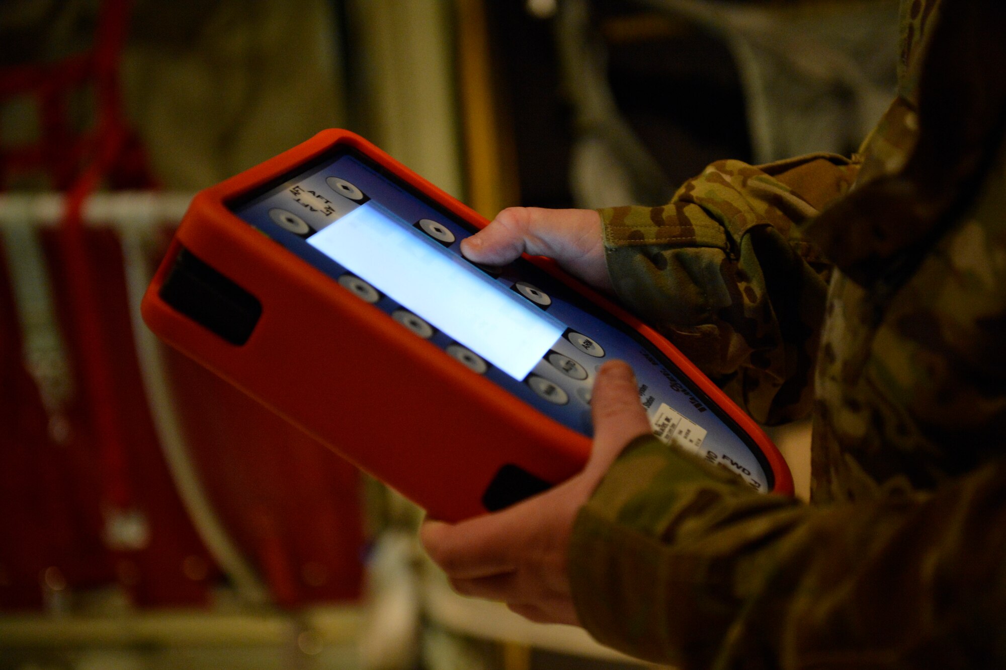 U.S. Air Force Master Sgt. Bradley Nulf, 774th Expeditionary Airlift Squadron evaluator loadmaster programs the Wireless Gate Release System before an airdrop at Bagram Airfield, Afghanistan Aug. 1, 2014. Loadmasters are using a new system for airdrops, the WGRS keeps them safely behind payloads exiting the aircraft. Nulf is deployed from Dyess Air Force Base, Texas and a native of Columbia City, Ind. (U.S. Air Force photo by Staff Sgt. Evelyn Chavez/Released)